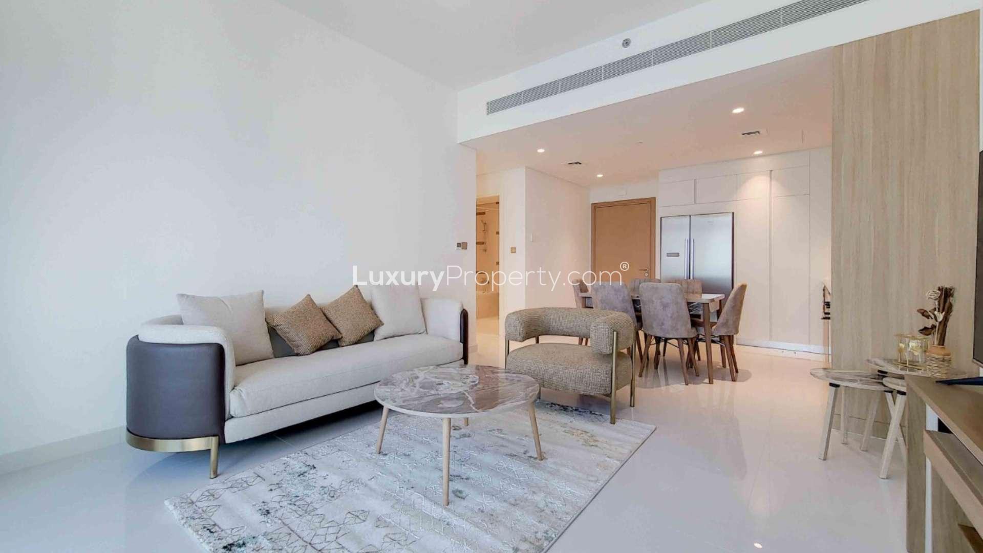 Modern living room in Dubai Harbour apartment with marina and Palm view balcony