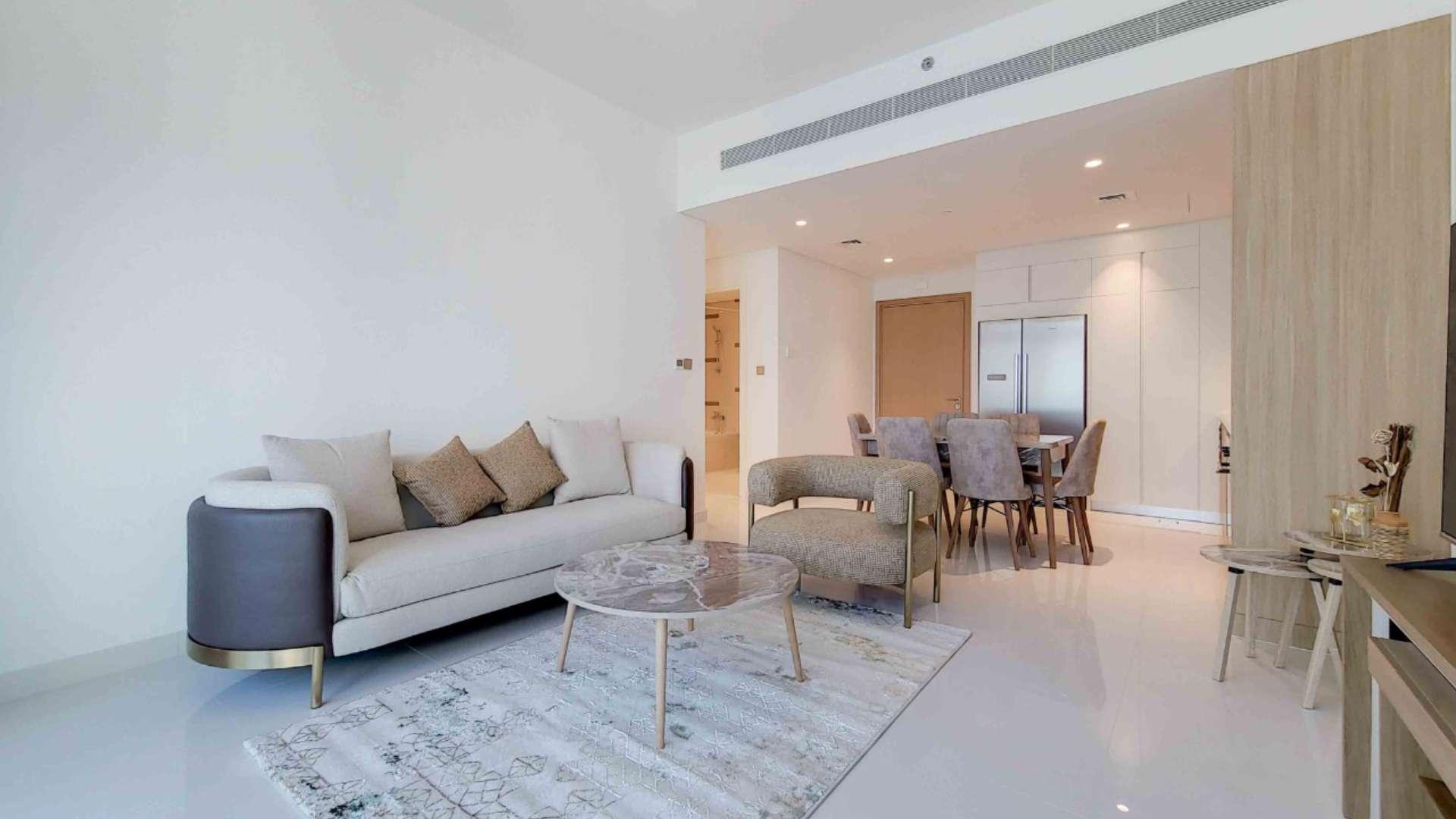 Modern living room in Dubai Harbour apartment with marina and Palm view balcony