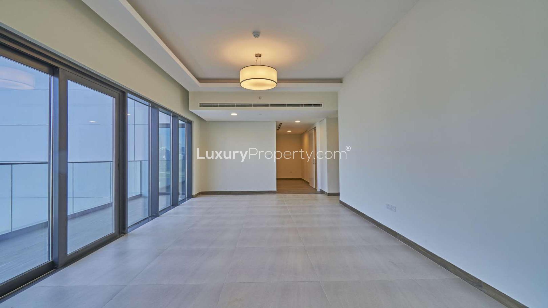 Spacious living room with large windows and city view in SOL Bay apartment, Business Bay Dubai
