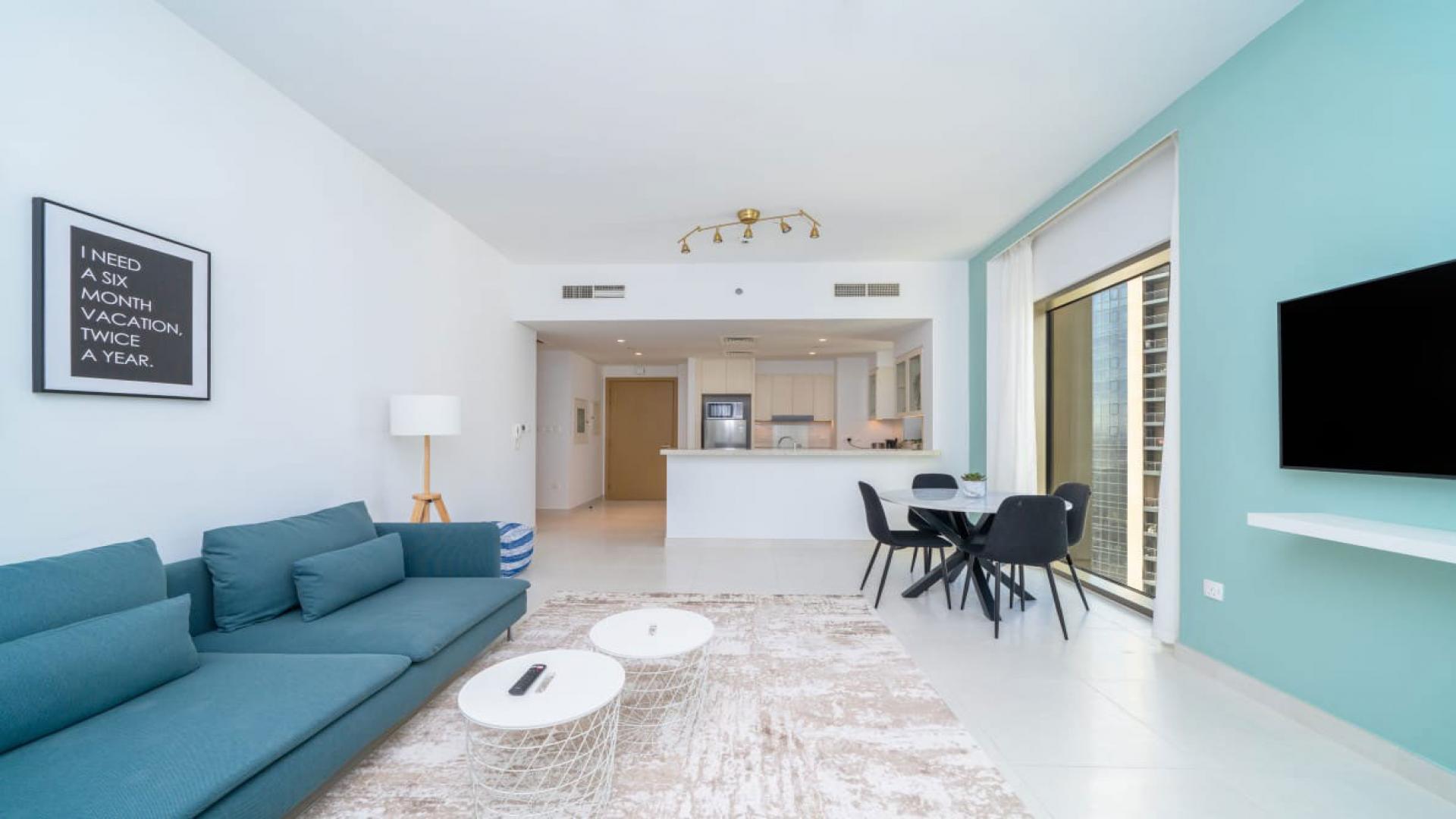 Modern living room in Creekside 18 apartment, Dubai Creek Harbour, with stunning balcony view