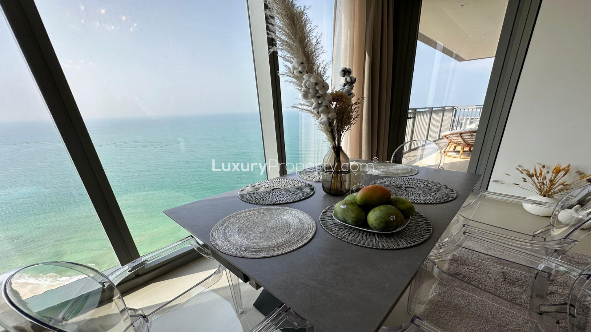 Modern living room in Dubai Marina apartment with waterfront views, elegant decor, and natural light