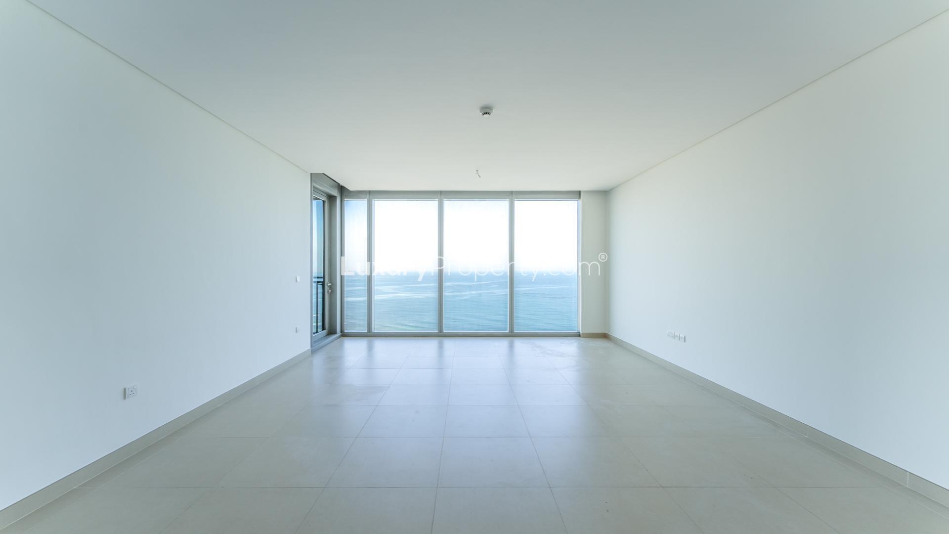 Luxurious empty living room with sea view windows in Dubai Marina apartment for rent