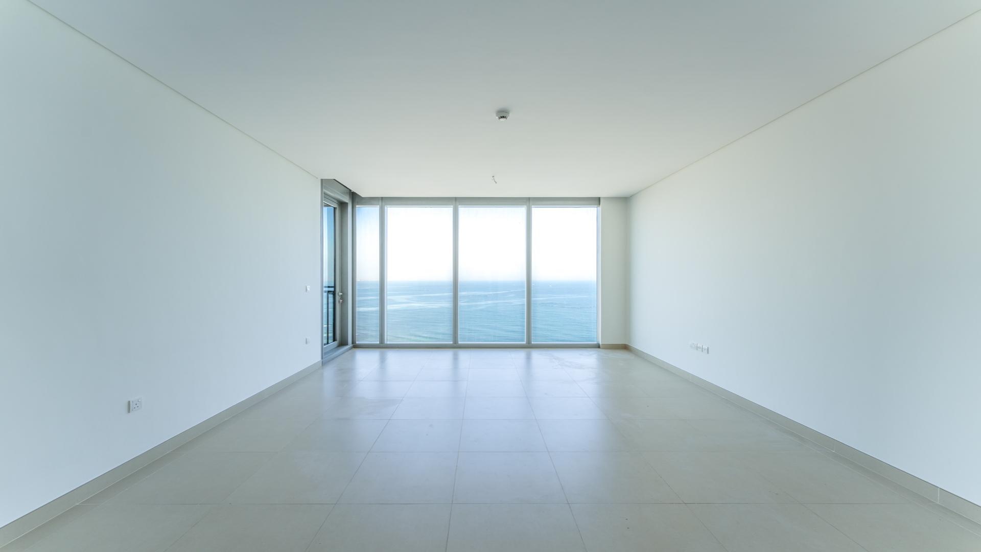 Luxurious empty living room with sea view windows in Dubai Marina apartment for rent