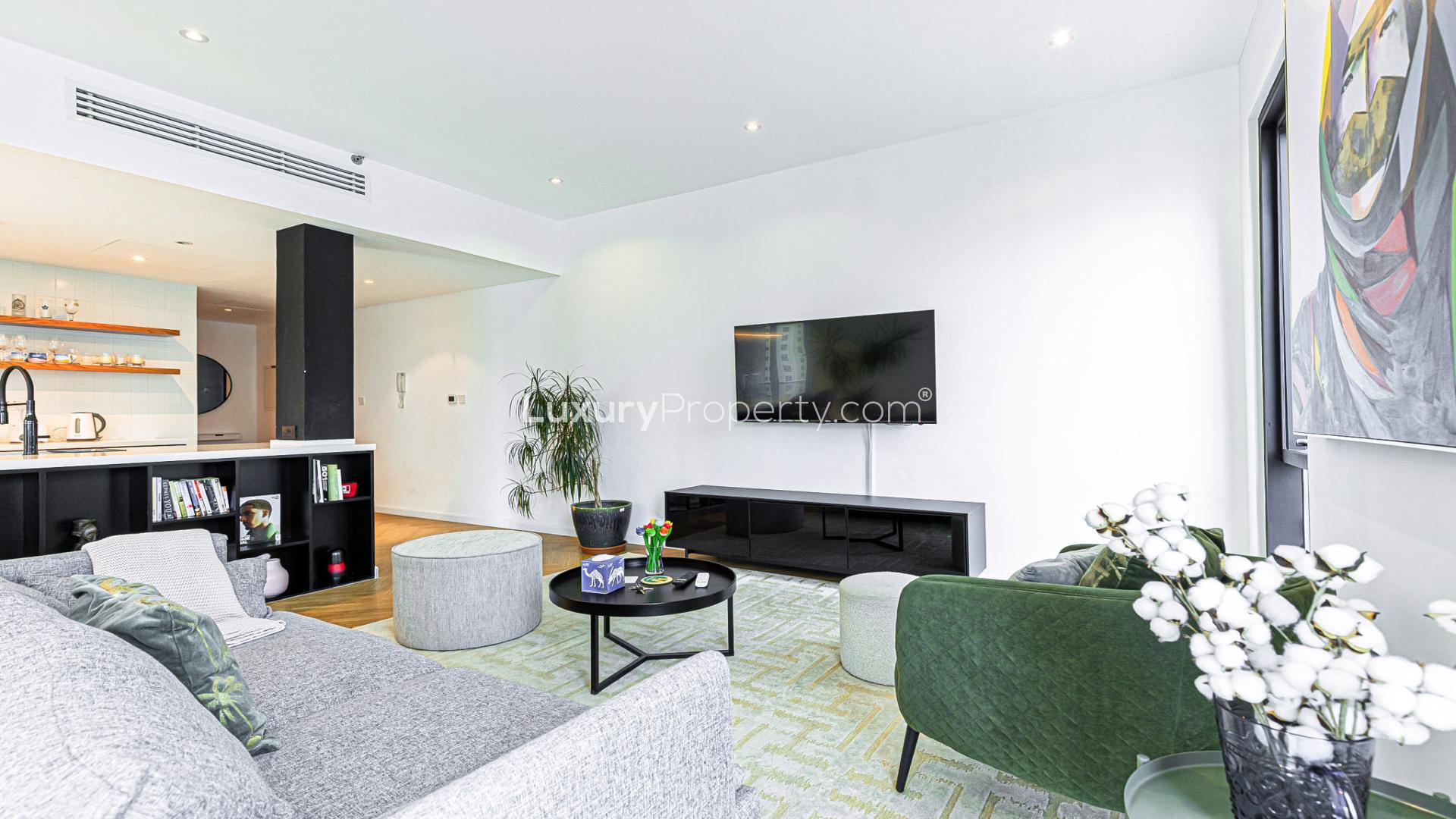 Dubai Marina Promenade apartment exterior with pool, high-rise buildings, and waterfront view