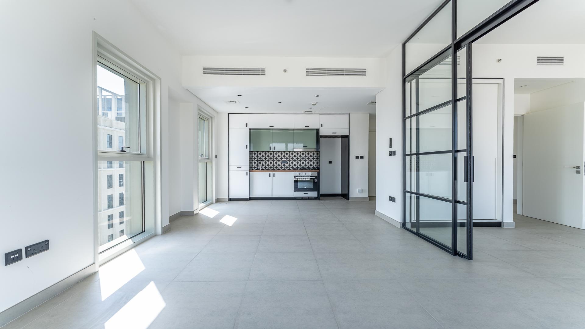 Modern living area in 2-bedroom apartment, Dubai Hills Estate, featuring sleek kitchen design