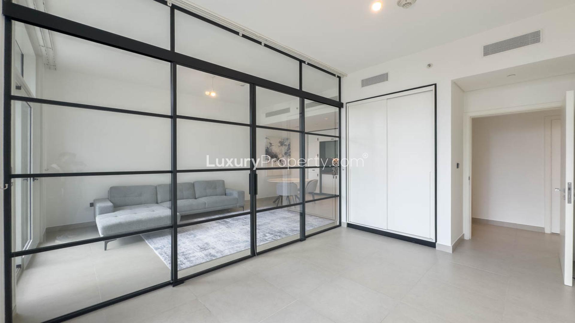 Modern living room in Dubai Hills Estate apartment, featuring a stylish sofa and dining area