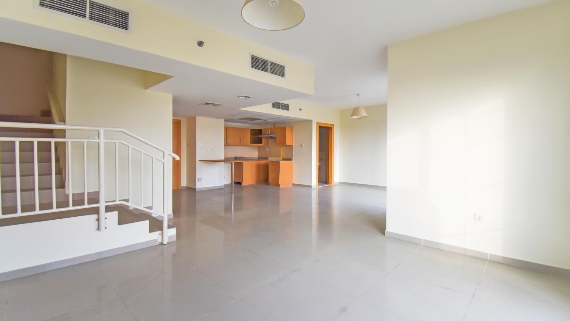 Spacious living area in 2-bedroom duplex apartment, Jumeirah Village Triangle, modern design, natural light