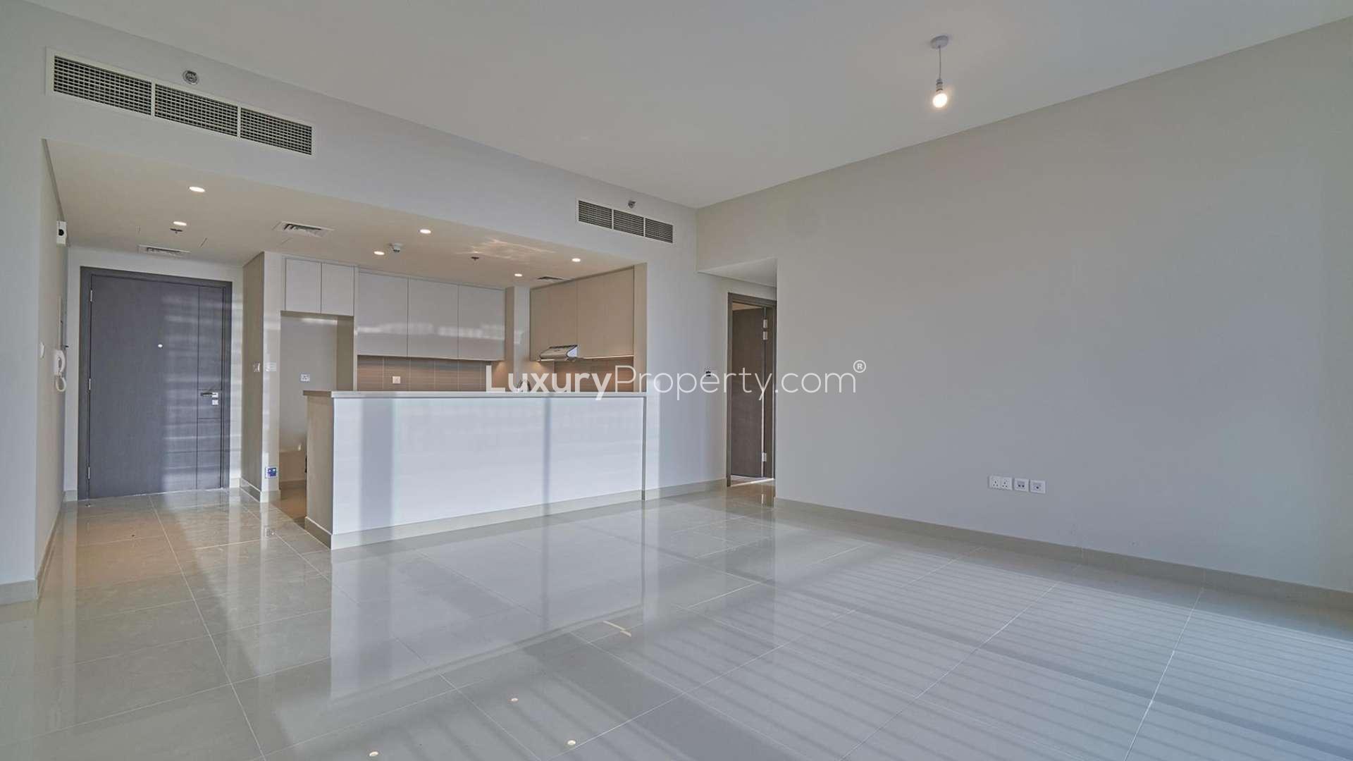 Empty living room with large windows and balcony in Dubai Creek Harbour apartment