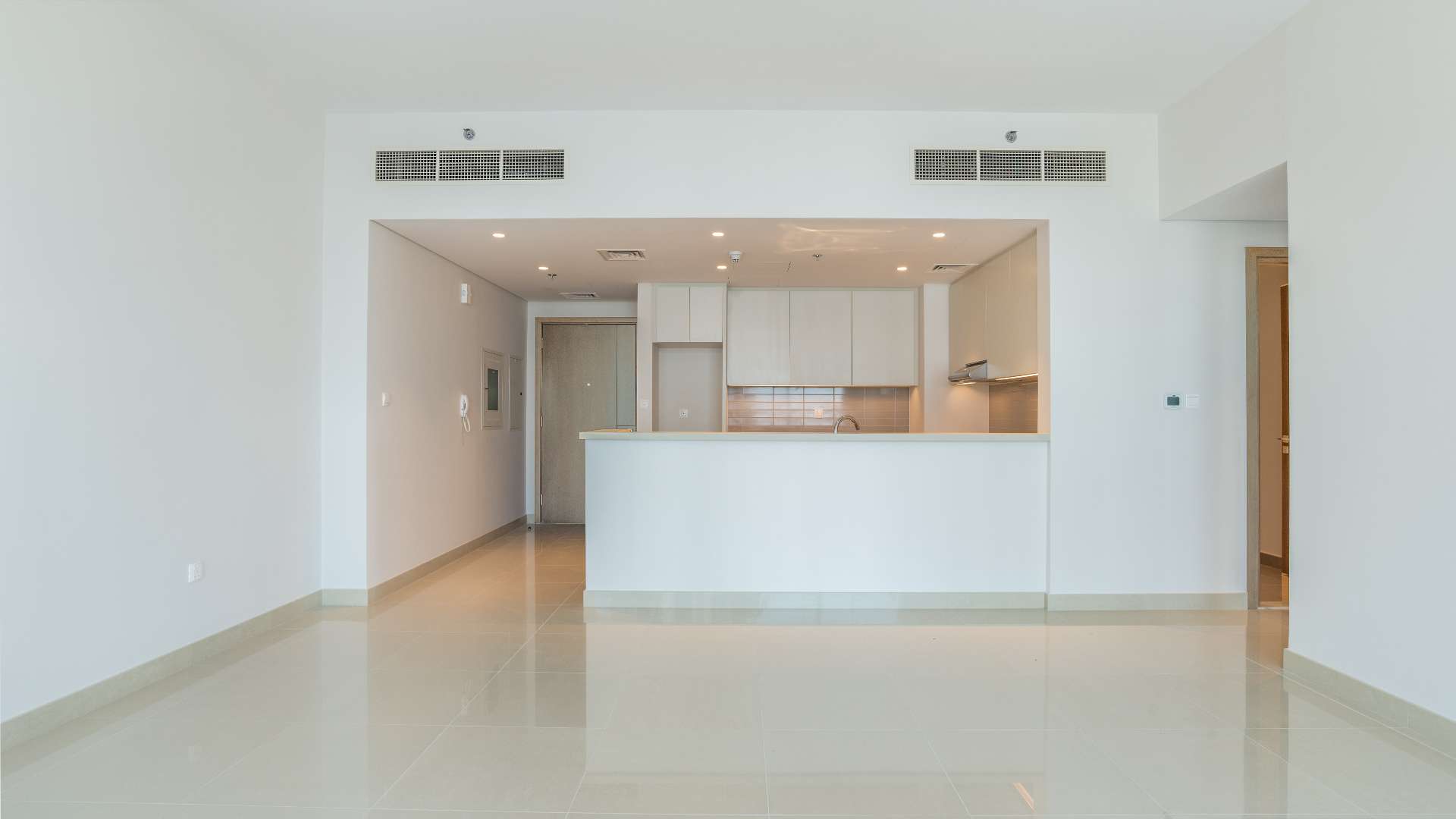 Modern kitchen and living area in Dubai Creek Harbour apartment for rent