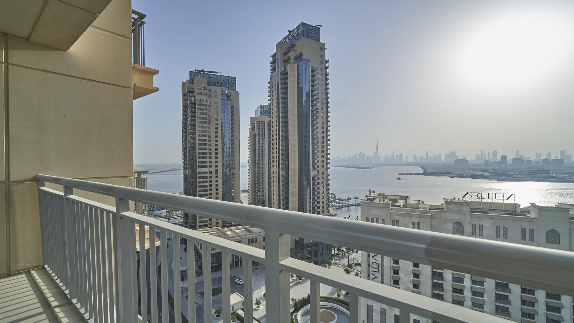 Vacant 2-bedroom apartment living room with balcony view in Harbour Views, Dubai Creek Harbour