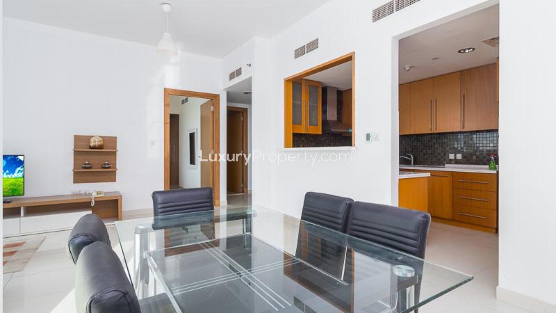 Modern furnished living room in Iris Blue, Dubai Marina apartment with large windows and city view
