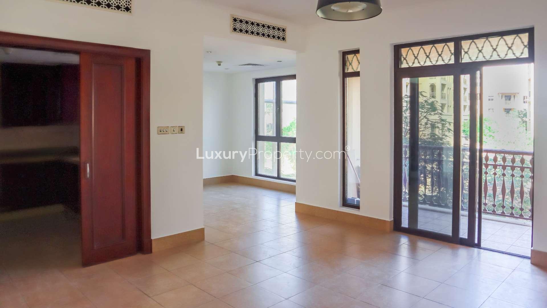 Alt text: "Apartment view of Kamoon, Old Town with city skyline, ideal rental location.",Bright living area with large windows in Kamoon apartment, Old Town, available for rent