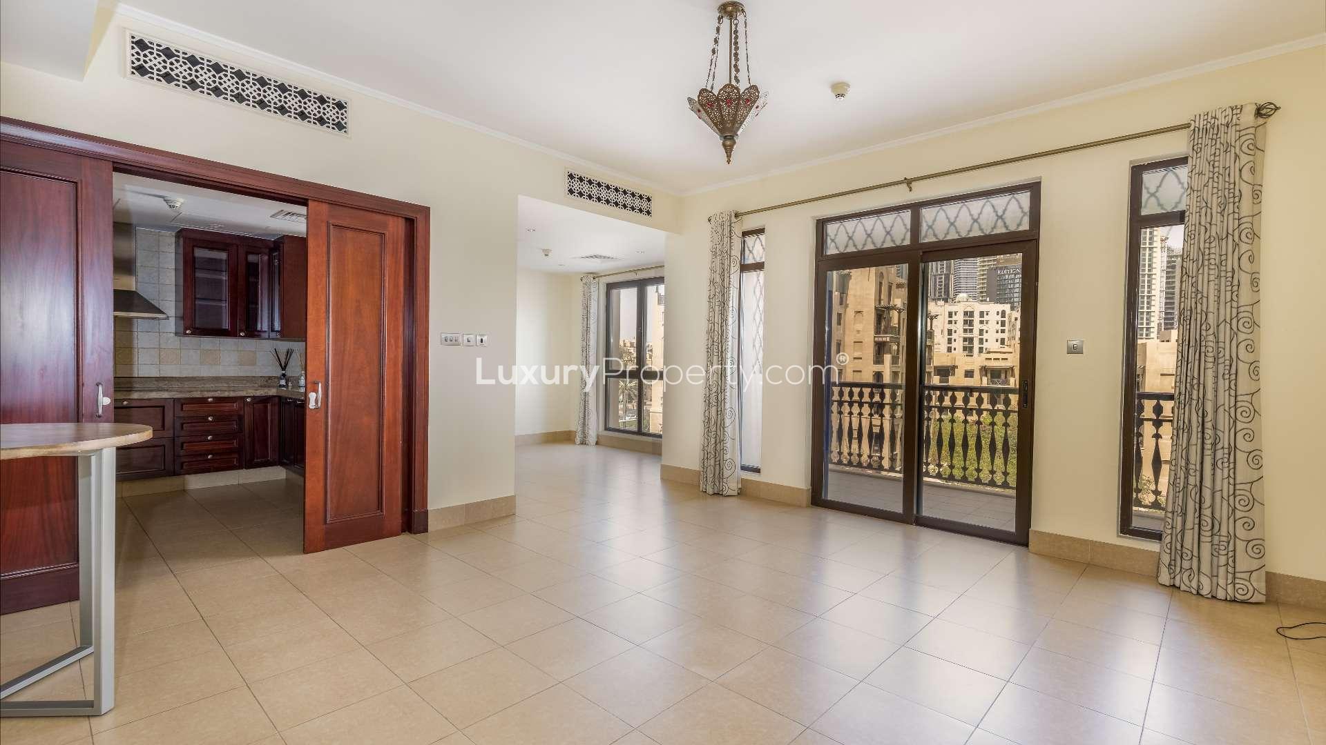 N/A,Empty living area with open kitchen in Kamoon apartment, Old Town, Dubai