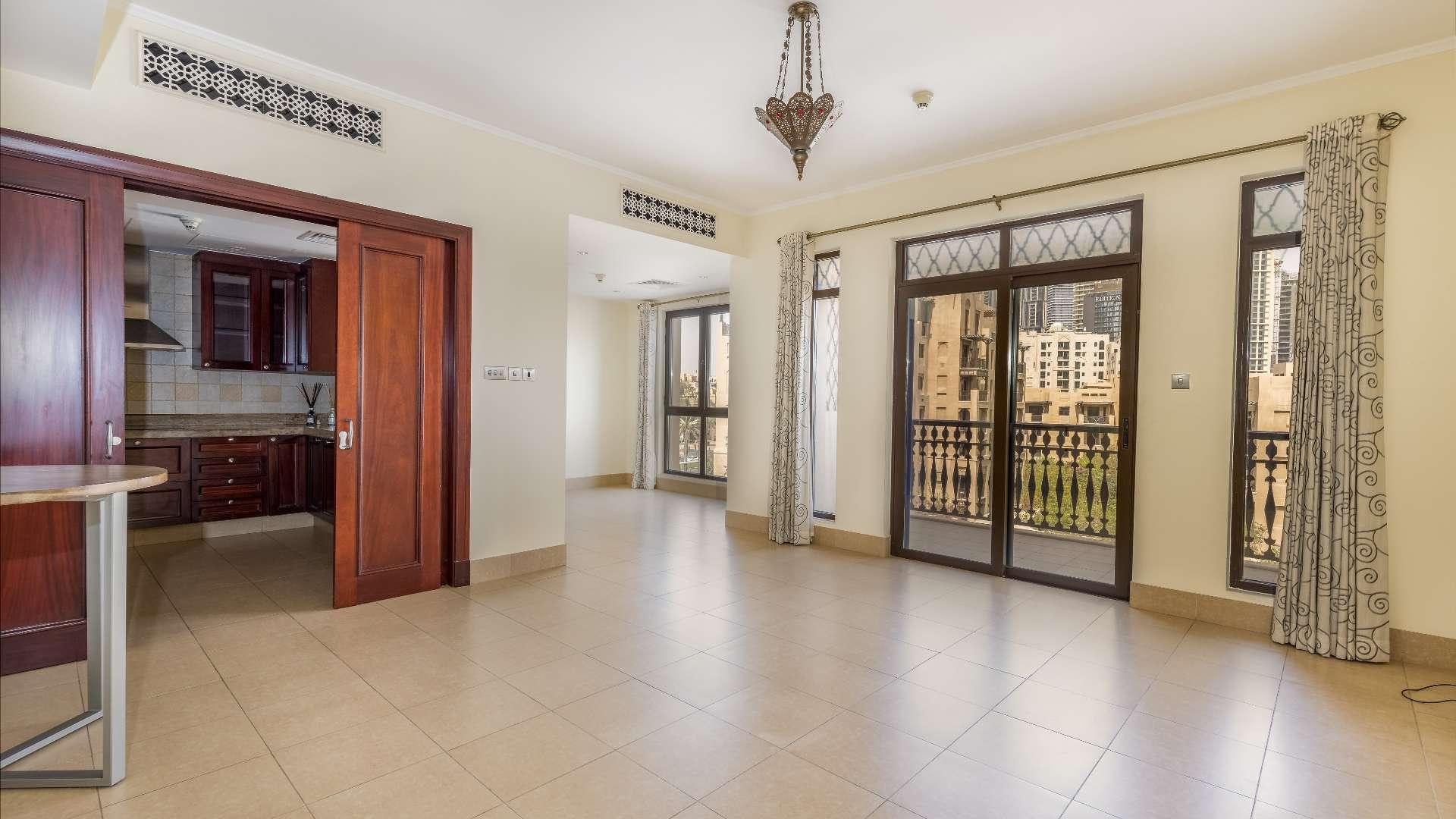 N/A,Empty living area with open kitchen in Kamoon apartment, Old Town, Dubai