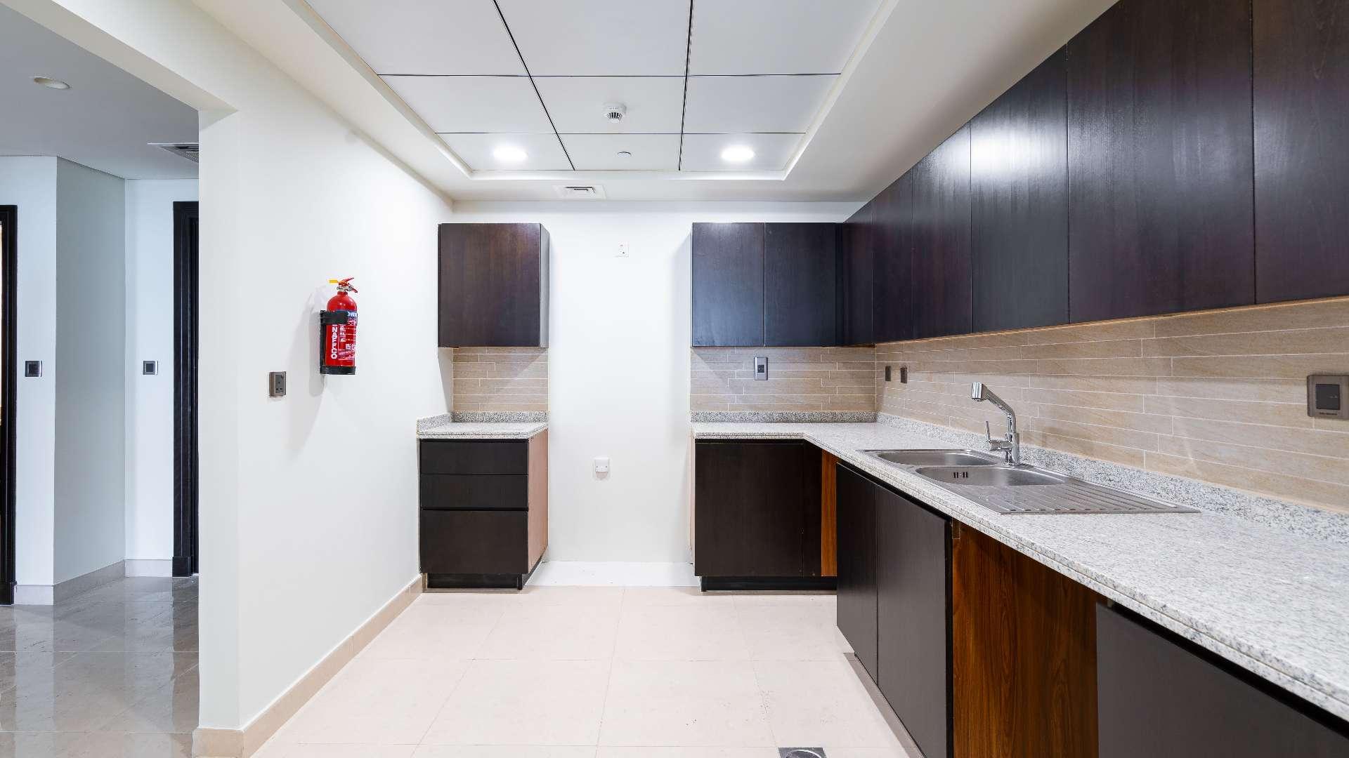 Empty living area in Palm Jumeirah apartment, featuring modern finishes and bright lighting