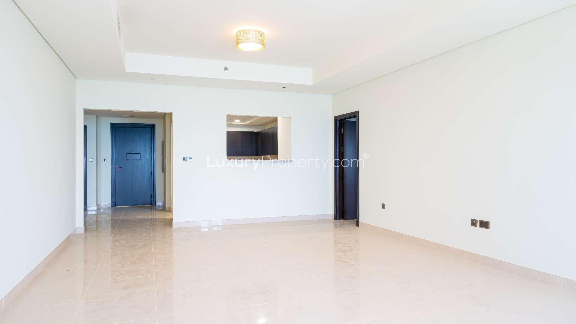 Empty living room with sea view windows in Palm Jumeirah apartment for rent