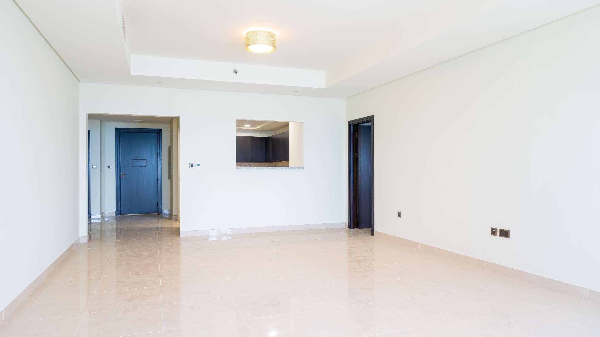 Empty living room with sea view windows in Palm Jumeirah apartment for rent