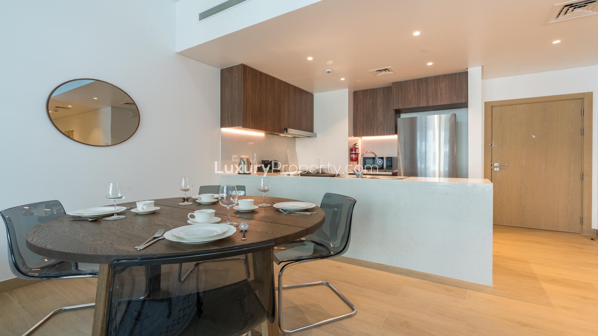Modern living room in Jumeirah La Mer apartment with open kitchen and stylish decor