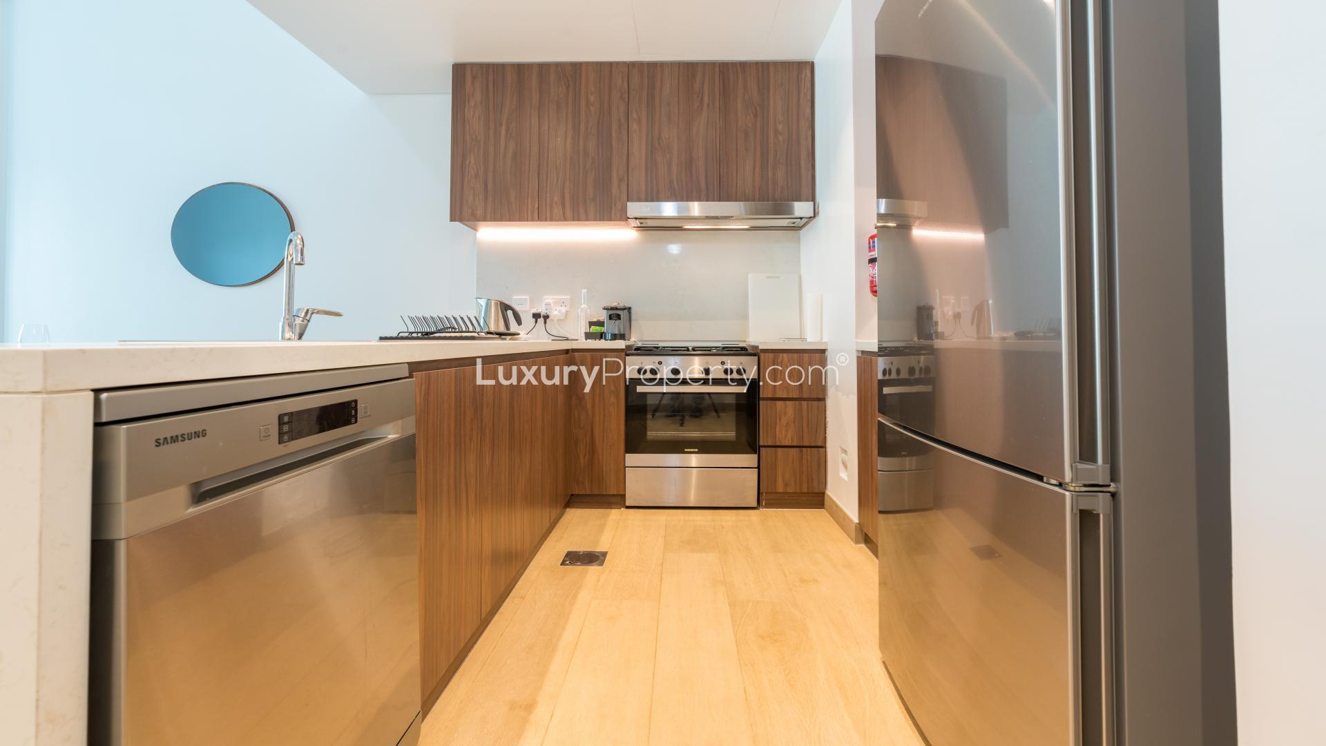 Modern kitchen in exclusive La Mer apartment, Jumeirah, featuring sleek design and spacious layout