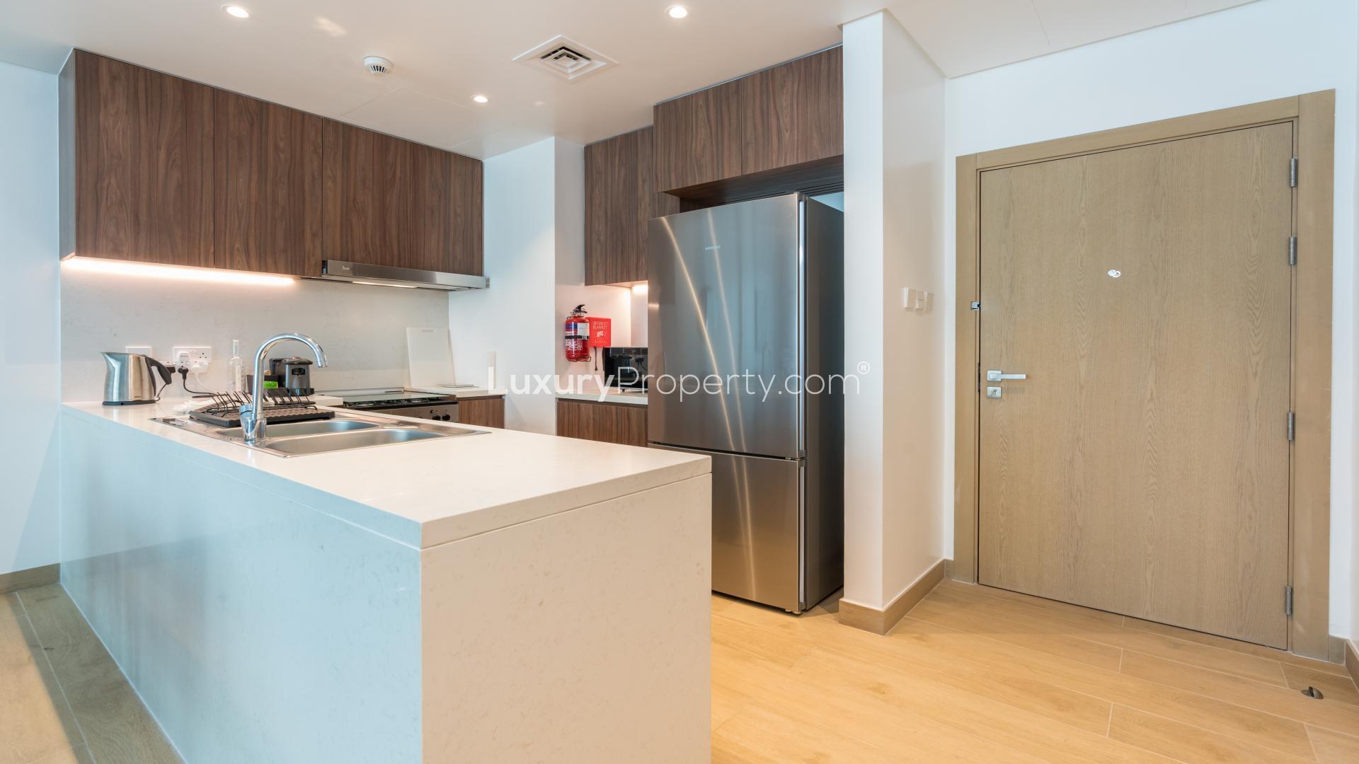Modern kitchen and dining area in La Mer apartment, Jumeirah, available for rent