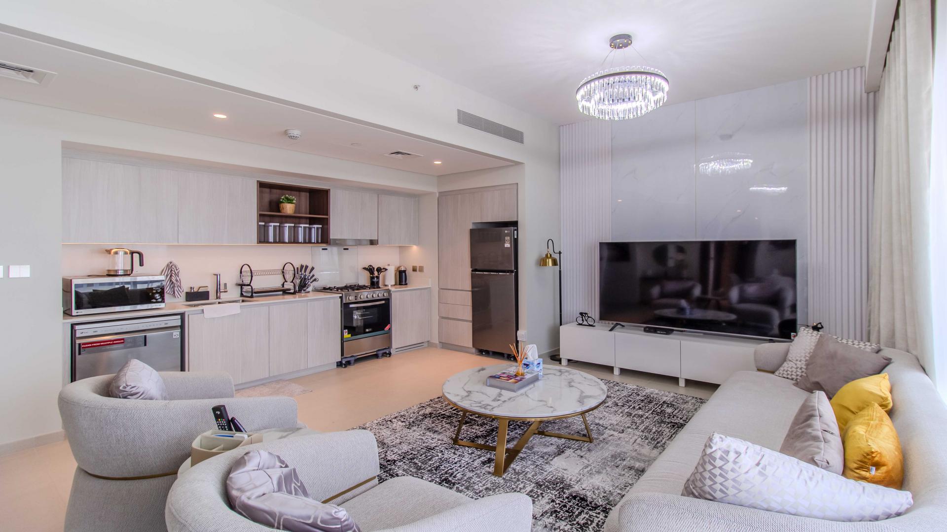 Modern living room in high-floor apartment, Dubai Creek Harbour, with elegant furnishings and decor