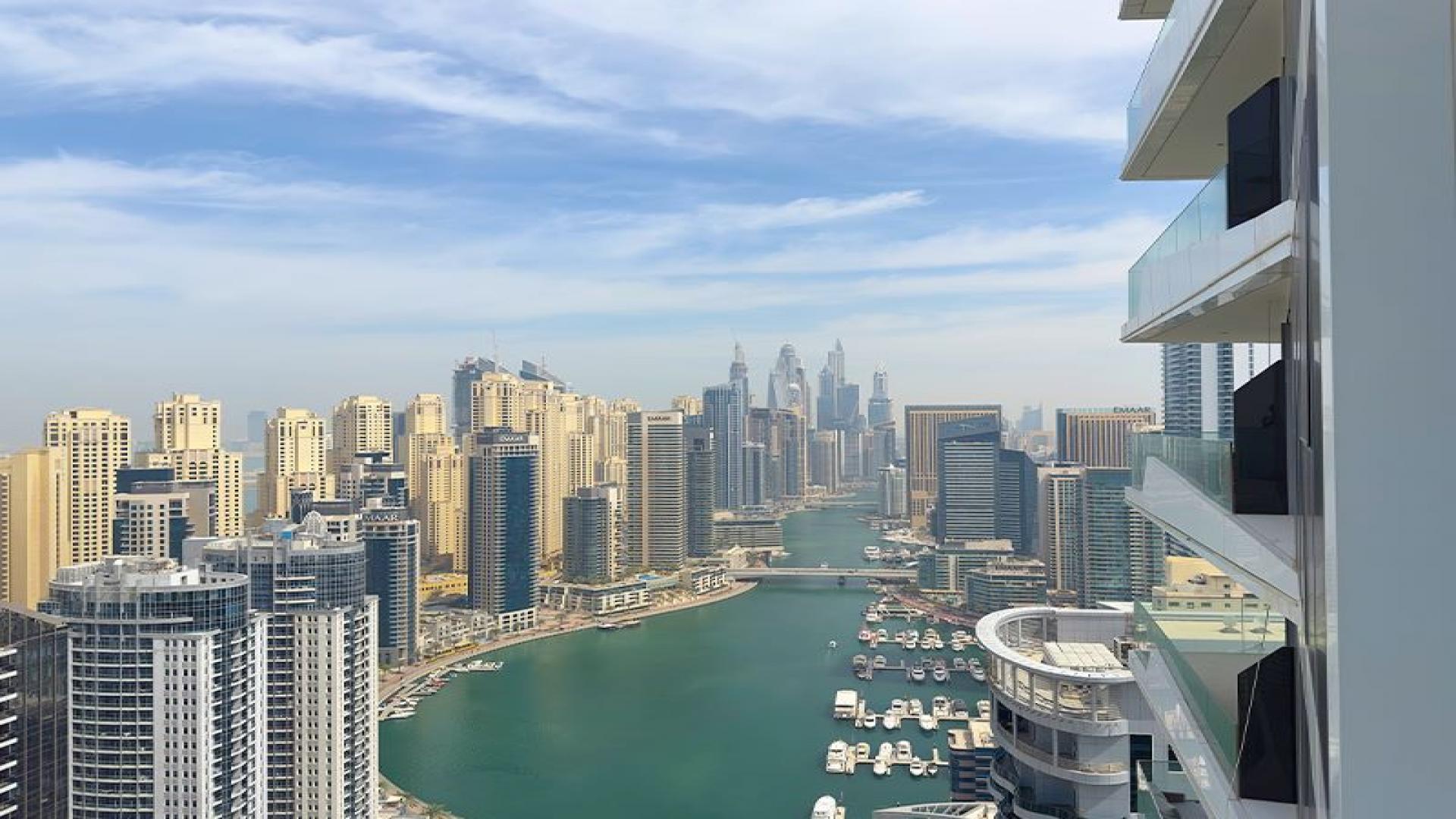 Bright living room with floor-to-ceiling windows, stunning views in Stella Maris, Dubai Marina