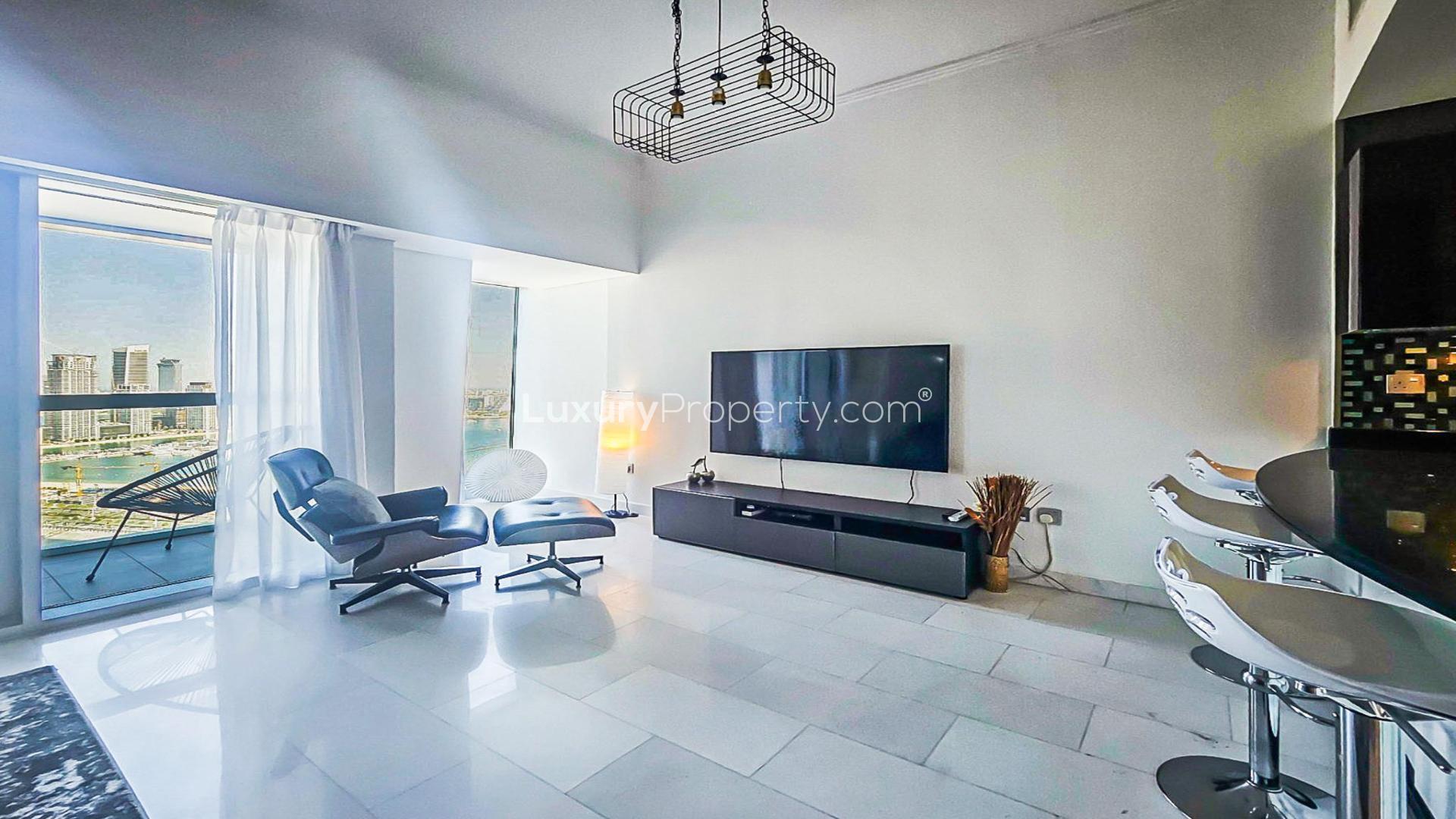 Modern living room in Cayan Tower apartment, Dubai Marina, featuring sleek furniture and decor