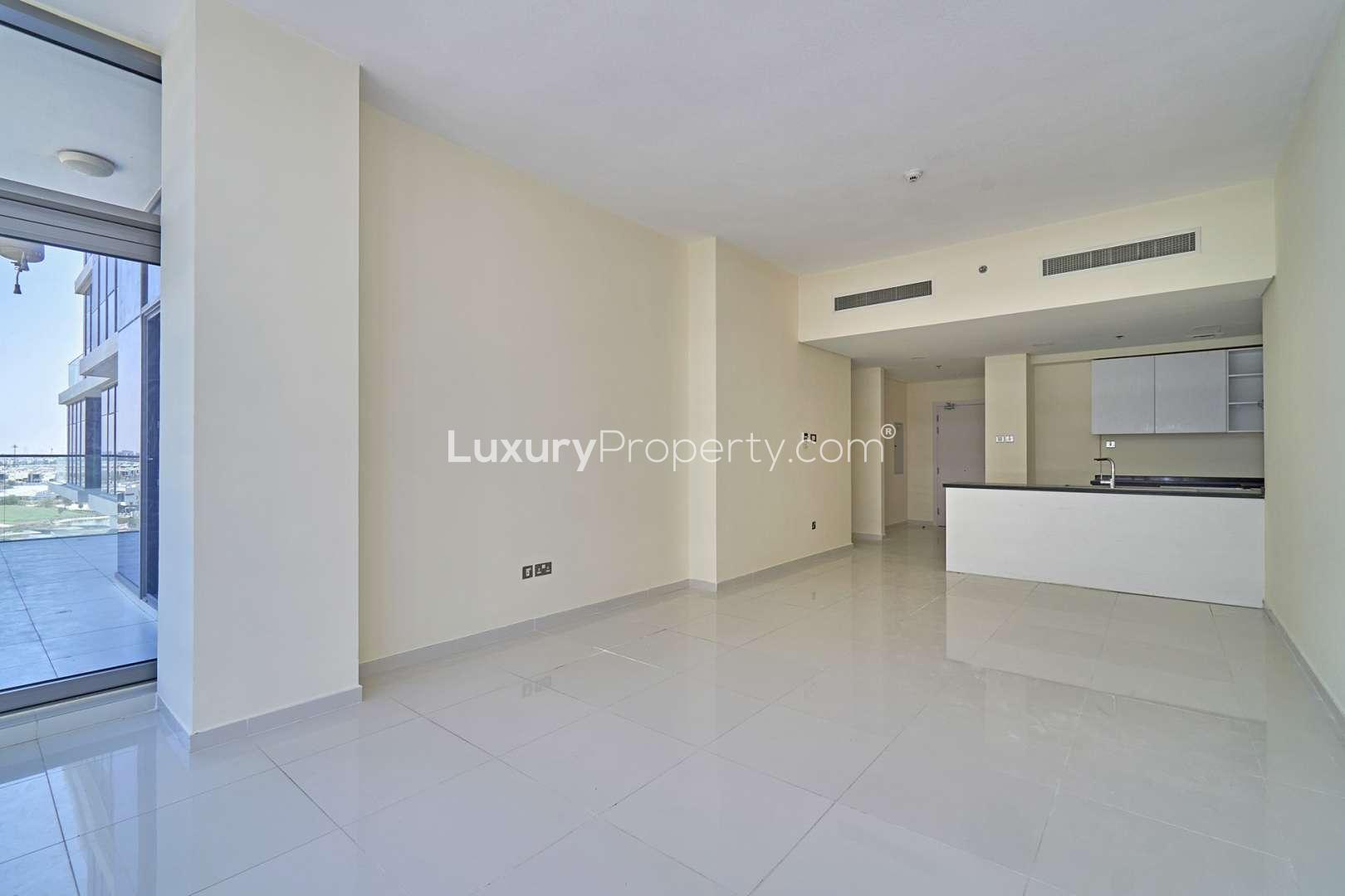 Spacious living room with large windows in Golf Vista apartment, DAMAC Hills