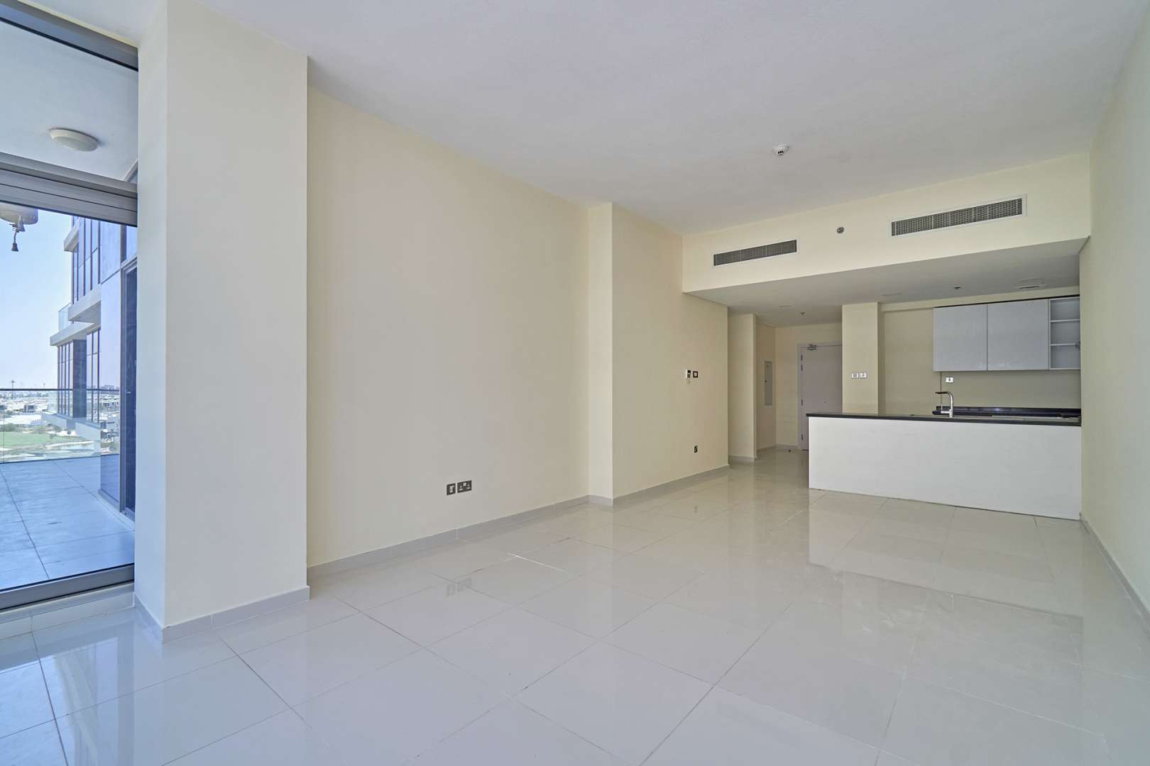 Spacious living room with large windows in Golf Vista apartment, DAMAC Hills