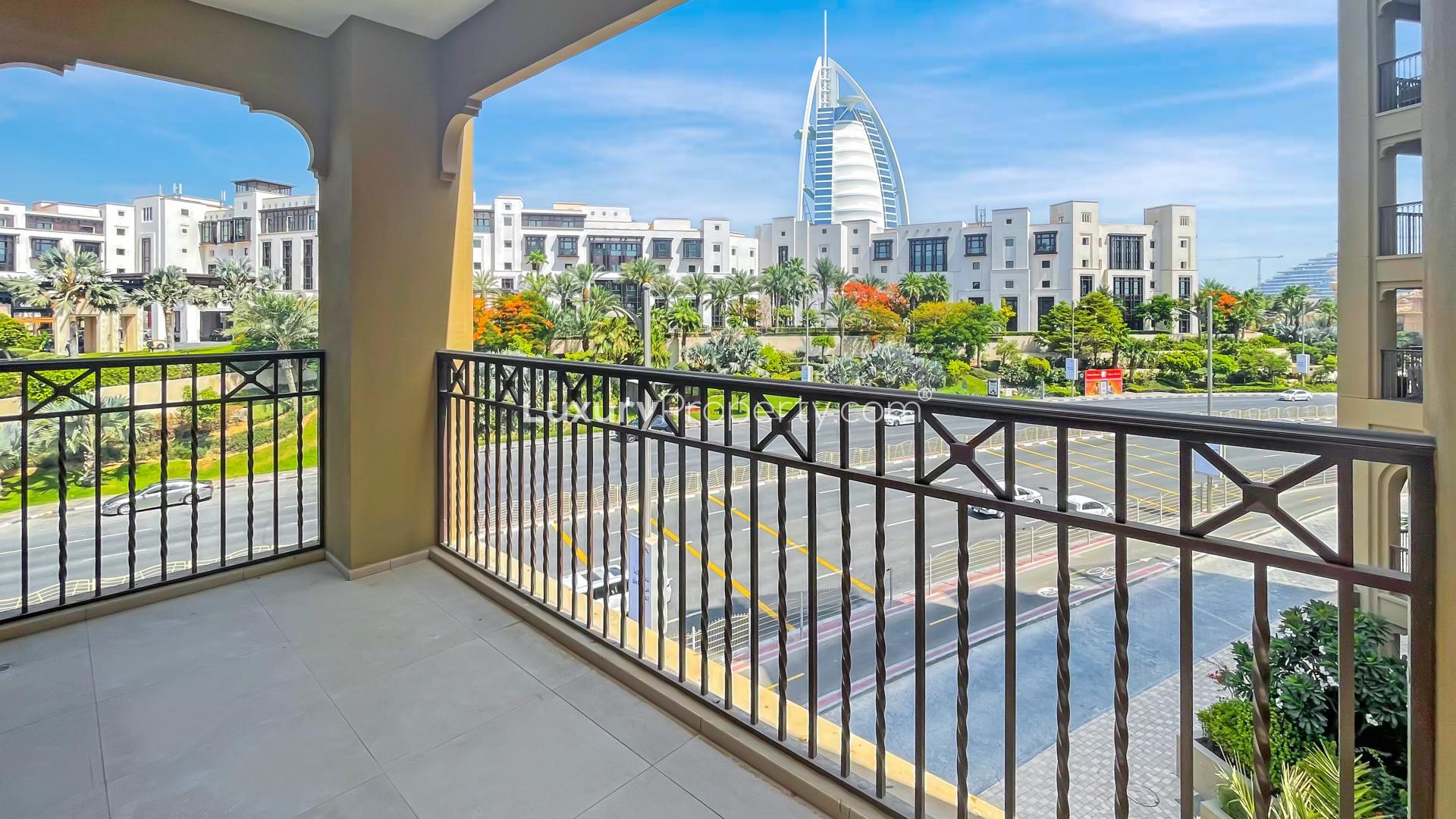 "Balcony view of iconic landmark from Madinat Jumeirah Living apartment in Umm Suqeim.","Spacious living room in Madinat Jumeirah apartment for rent, featuring large windows and tiled floor.",Bright living area in Madinat Jumeirah Living apartment, floor-to-ceiling windows, Umm Suqeim