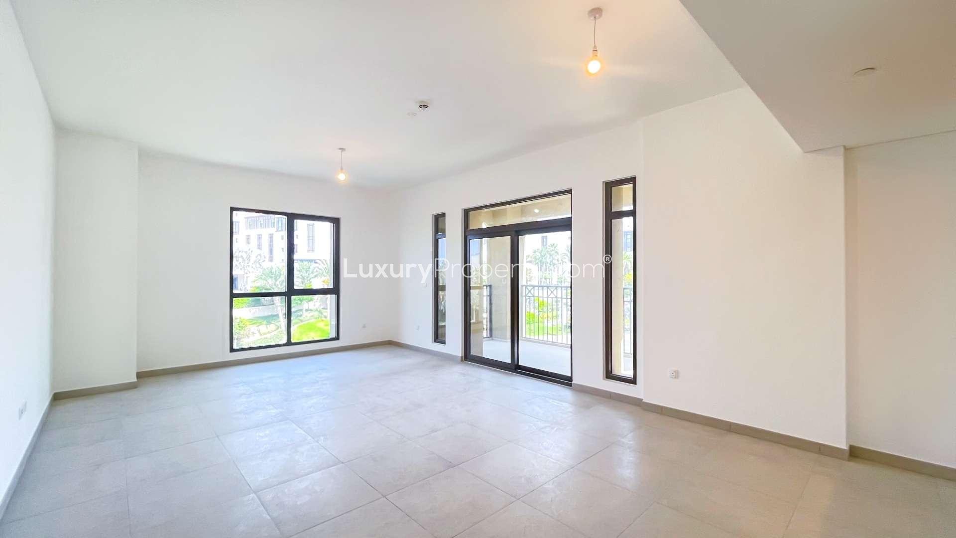 "Stunning apartment view, iconic Burj Al Arab, Madinat Jumeirah Living, Umm Suqeim, Dubai.",Empty living room in Madinat Jumeirah apartment with large windows, tiled floor, bright lighting