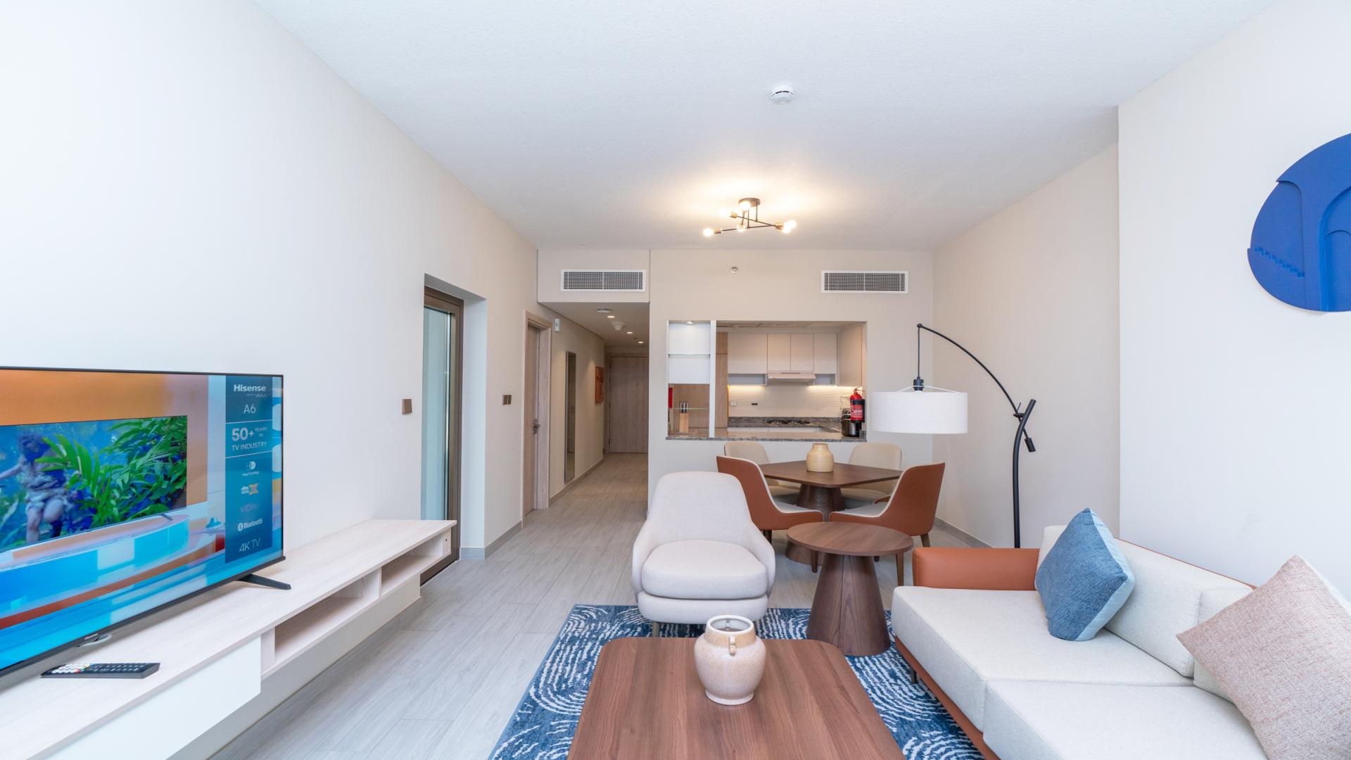 Fully furnished living and dining area with canal view in Business Bay apartment