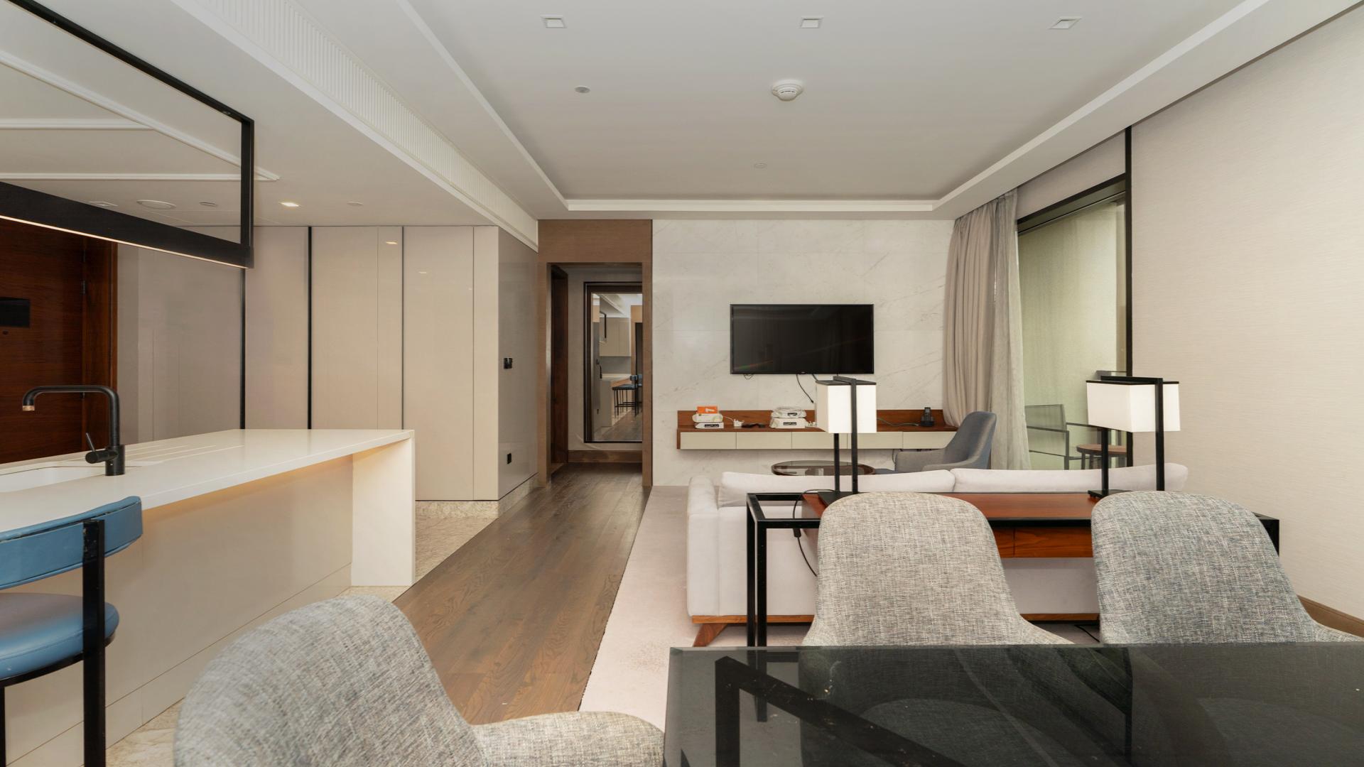 Modern living room in Bluewaters Residences apartment for rent, featuring stylish decor and balcony