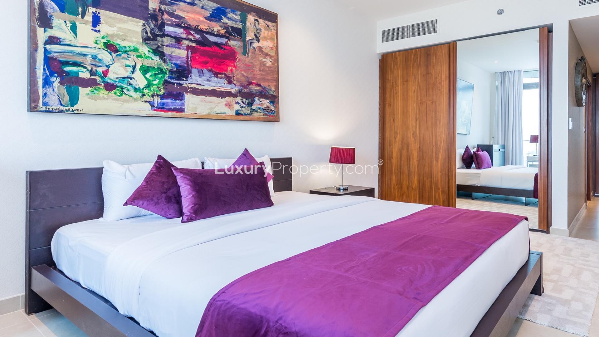 "Modern bedroom in Marina Gate apartment with city view, Dubai Marina, two-bedroom rental.",Stylish bedroom in two-bedroom apartment, Marina Gate, Dubai Marina, with modern decor and artwork