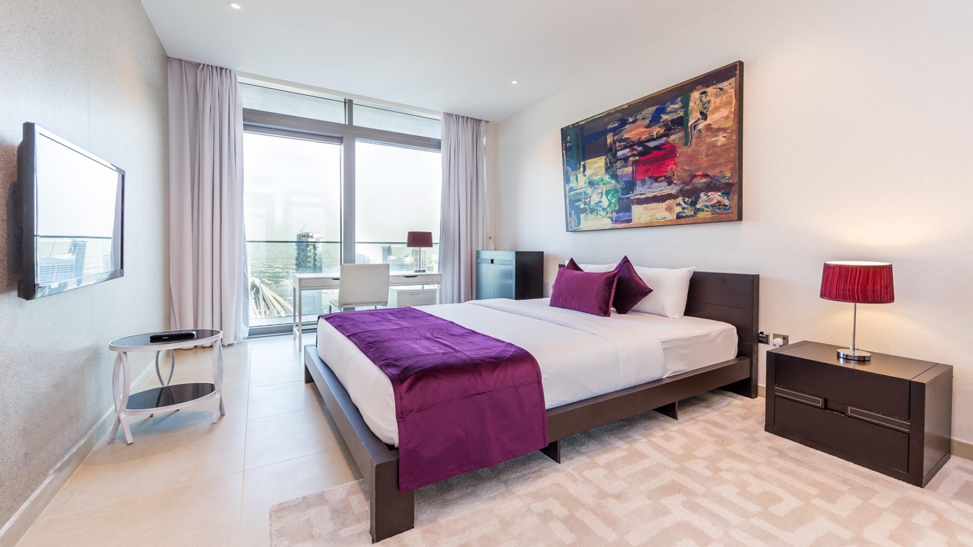 Stylish bedroom in two-bedroom apartment, Marina Gate, Dubai Marina, with modern decor and balcony view