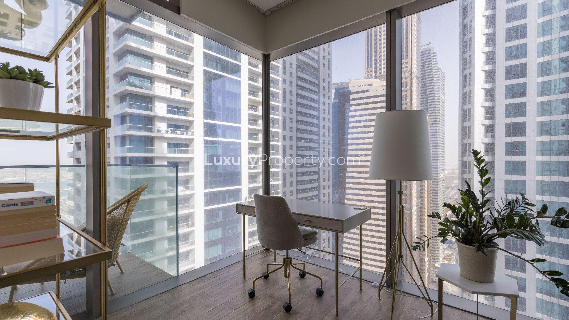 Luxury apartment dining area with modern furnishings, open kitchen, and marina views at Marina Gate
