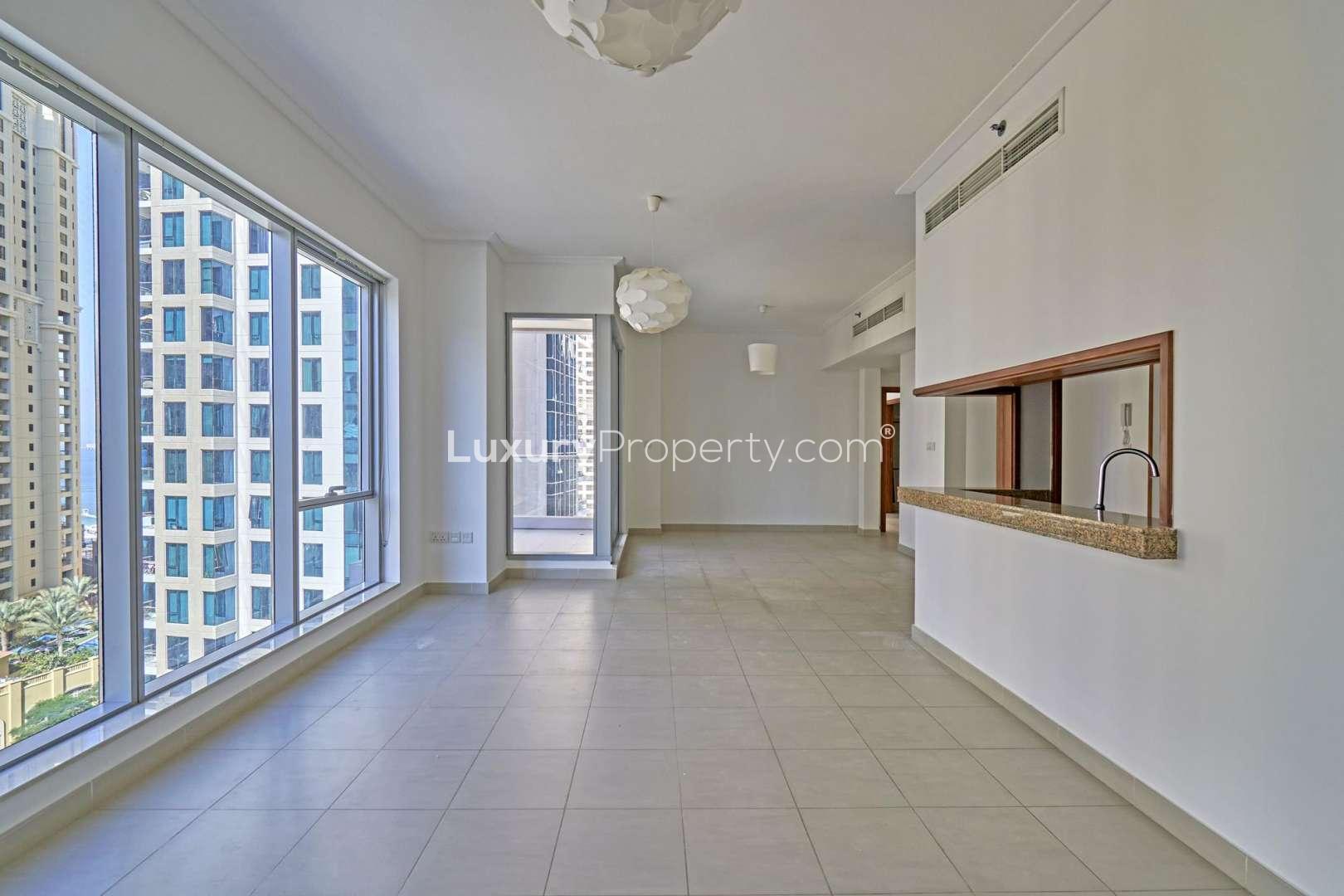 Empty room in 2-bedroom apartment, wooden doors, tiled floor, Dubai Marina rental