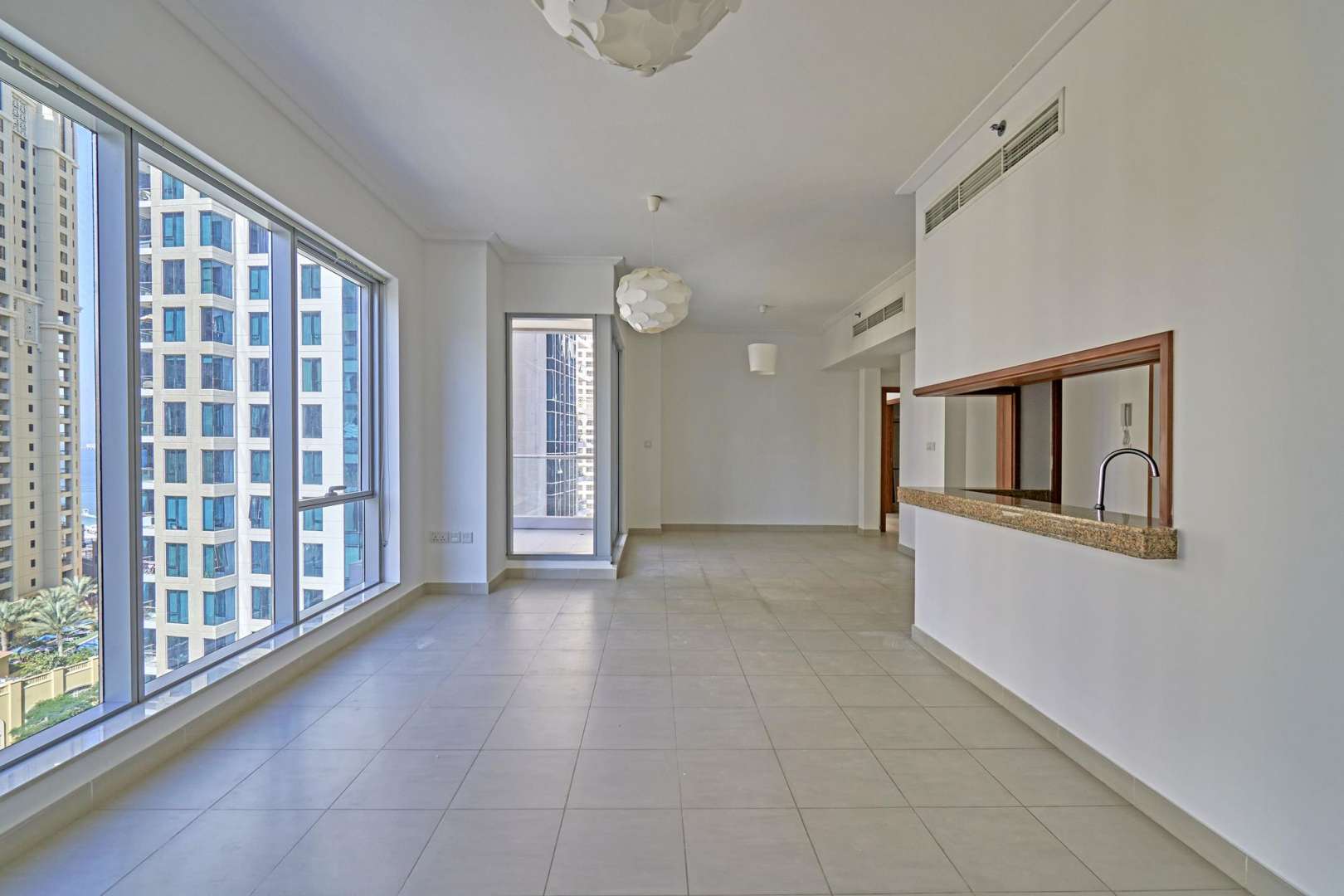 Empty room in 2-bedroom apartment, wooden doors, tiled floor, Dubai Marina rental