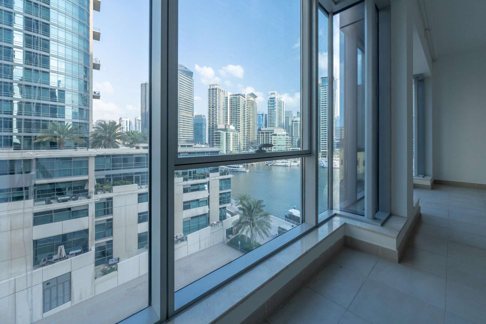 Spacious living area in Marina Promenade apartment, Dubai Marina, with large windows and modern finishes