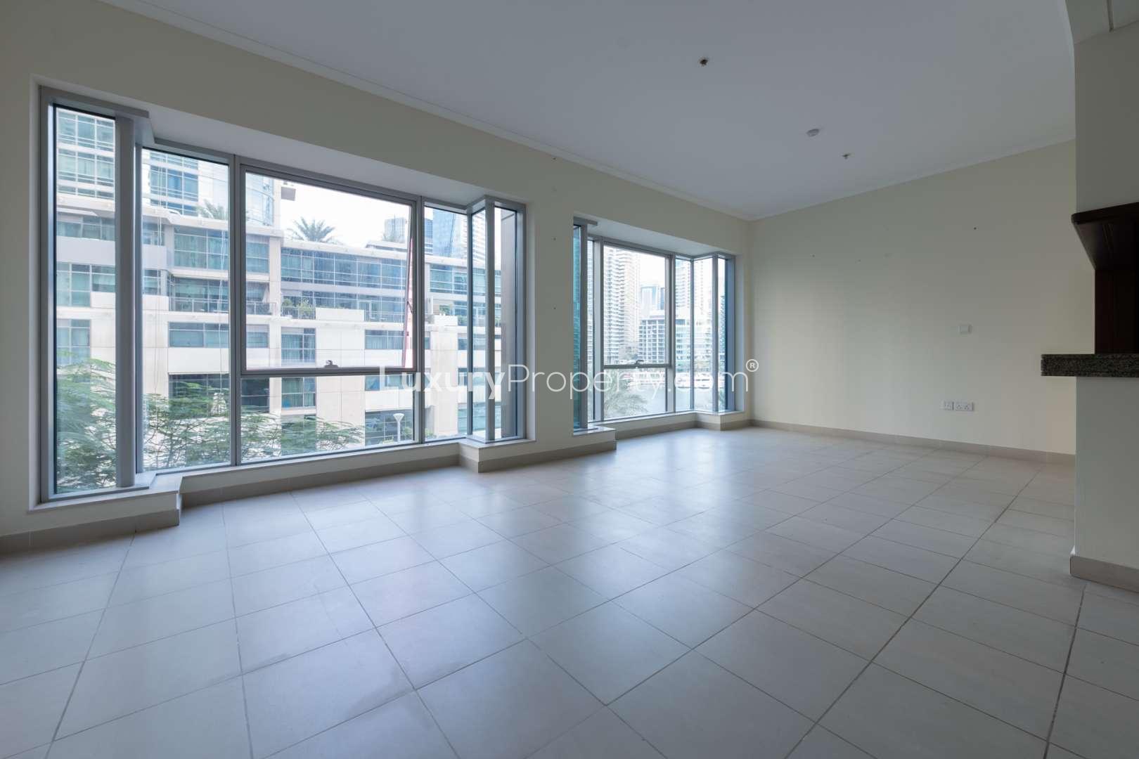 Empty room with tiled floor, open bathroom door in Dubai Marina apartment for rent
