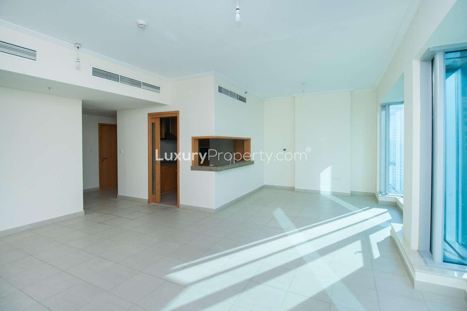 Bright living room with large windows showcasing Marina views in Dubai Marina apartment