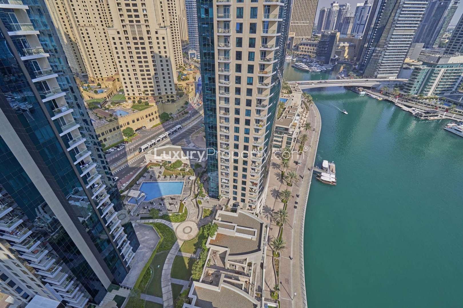 "Stunning view from Beauport Tower apartment balcony in Dubai Marina, showcasing city skyline.",Aerial view of Beauport Tower, Dubai Marina waterfront and pool, Marina Promenade apartment