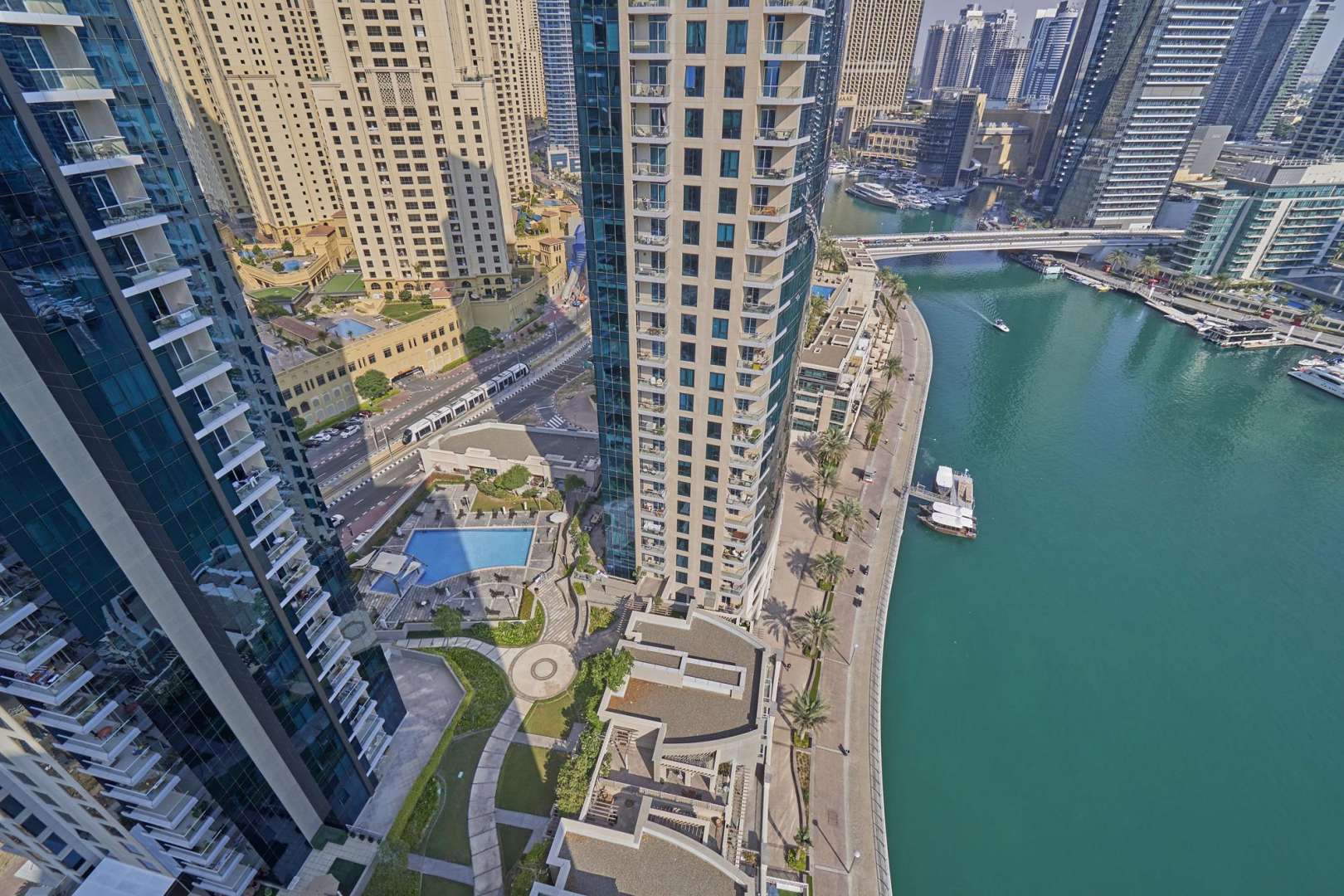 "Stunning view from Beauport Tower apartment balcony in Dubai Marina, showcasing city skyline.",Aerial view of Beauport Tower, Dubai Marina waterfront and pool, Marina Promenade apartment