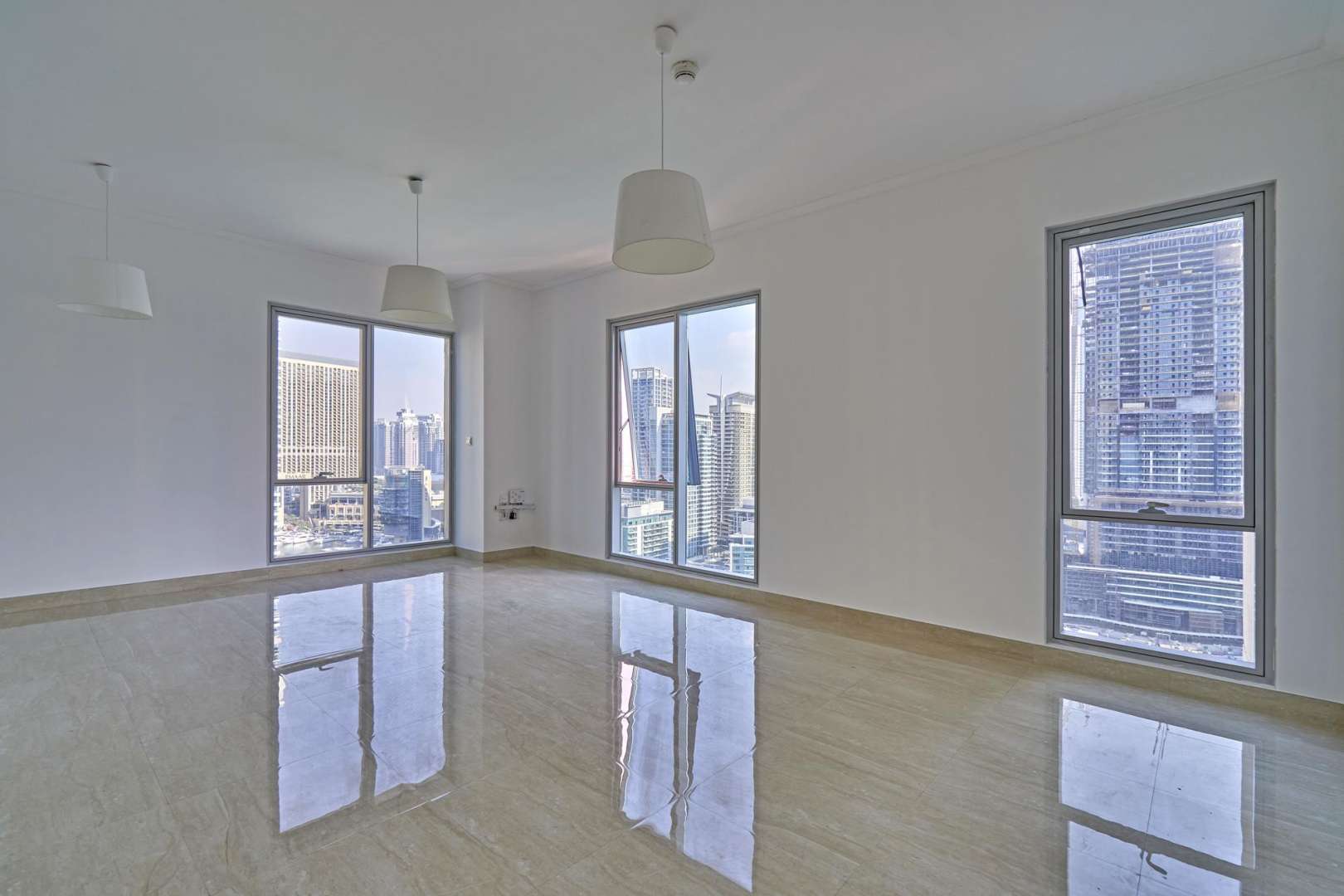 Spacious living area with large windows in Beauport Tower, Dubai Marina apartment
