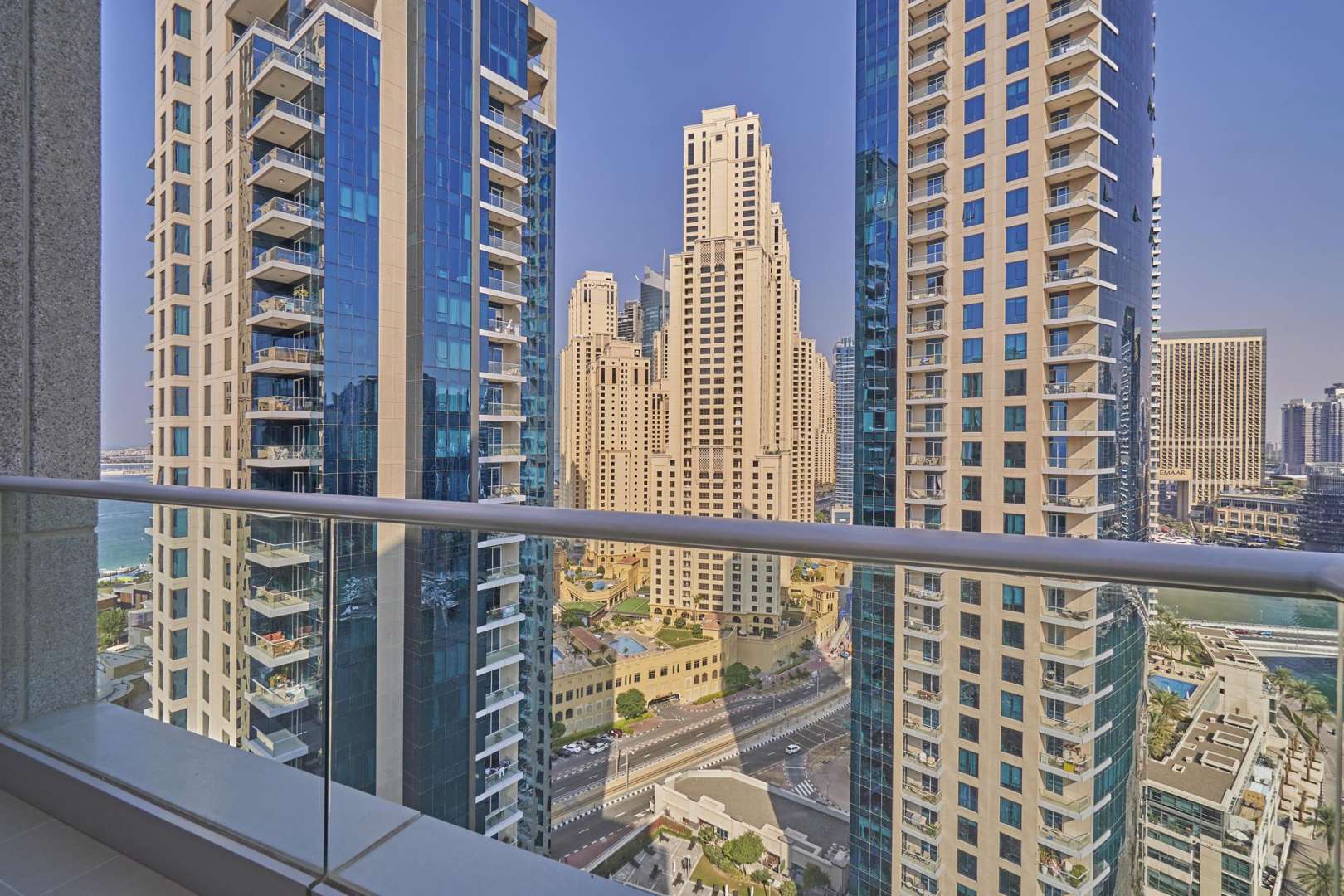 Balcony view from Beauport Tower apartment overlooking Dubai Marina waterfront and skyline