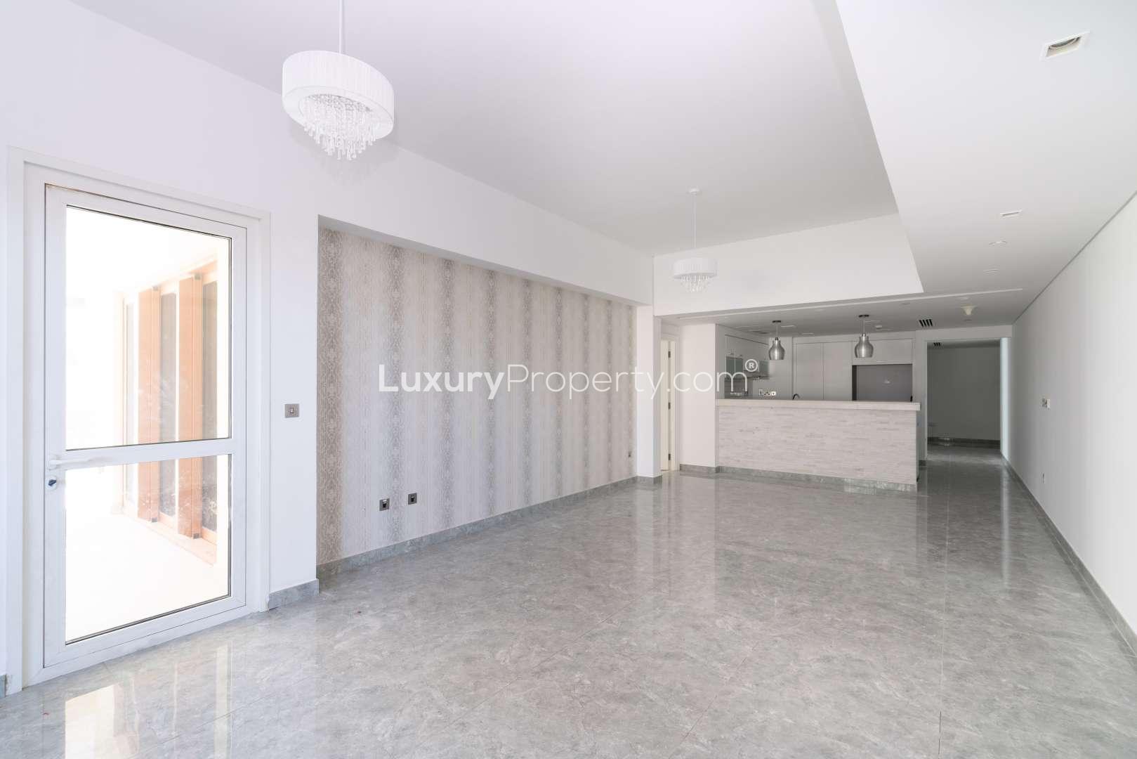 Modern kitchen in two-bedroom apartment, Marina Residence, Palm Jumeirah, featuring sleek white cabinetry