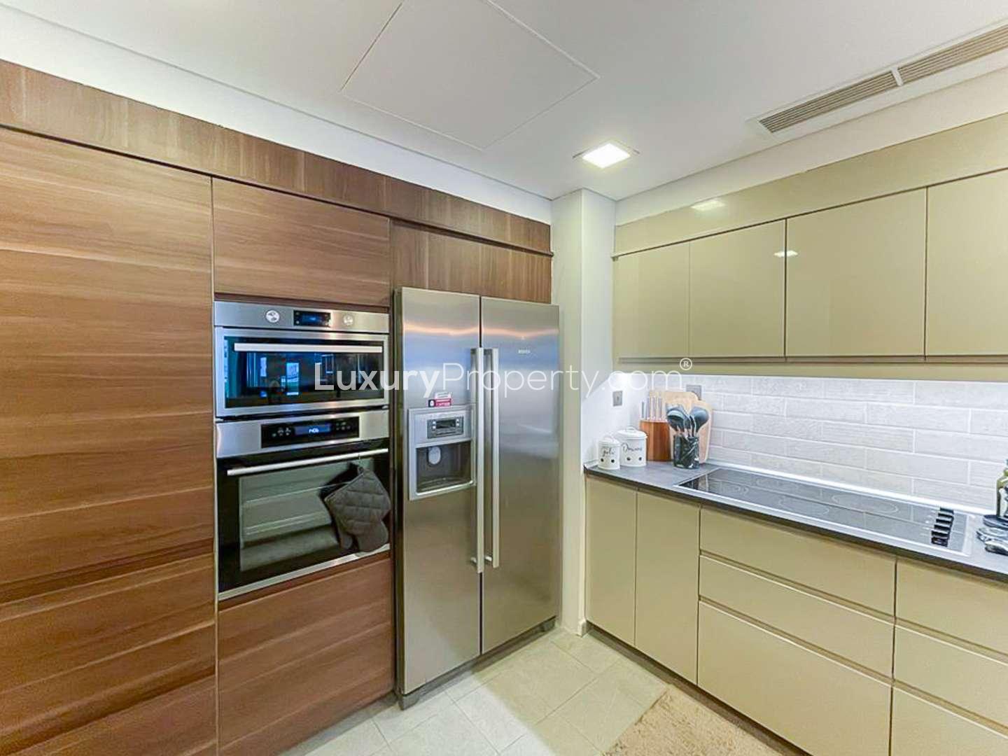 Modern kitchen in upgraded Palm Jumeirah apartment, featuring sleek cabinetry and contemporary design