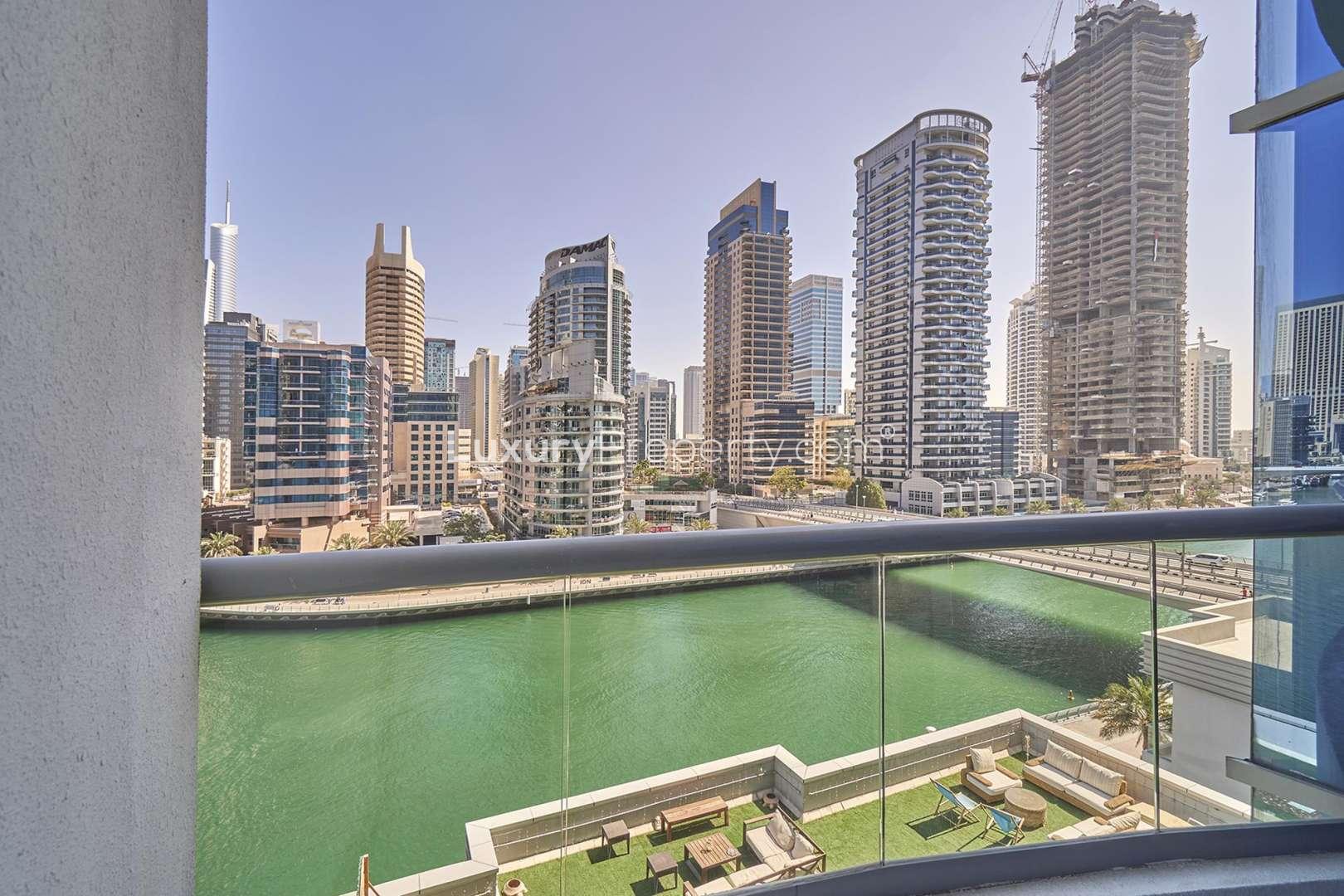 Spacious living area with large windows in Dubai Marina apartment for rent