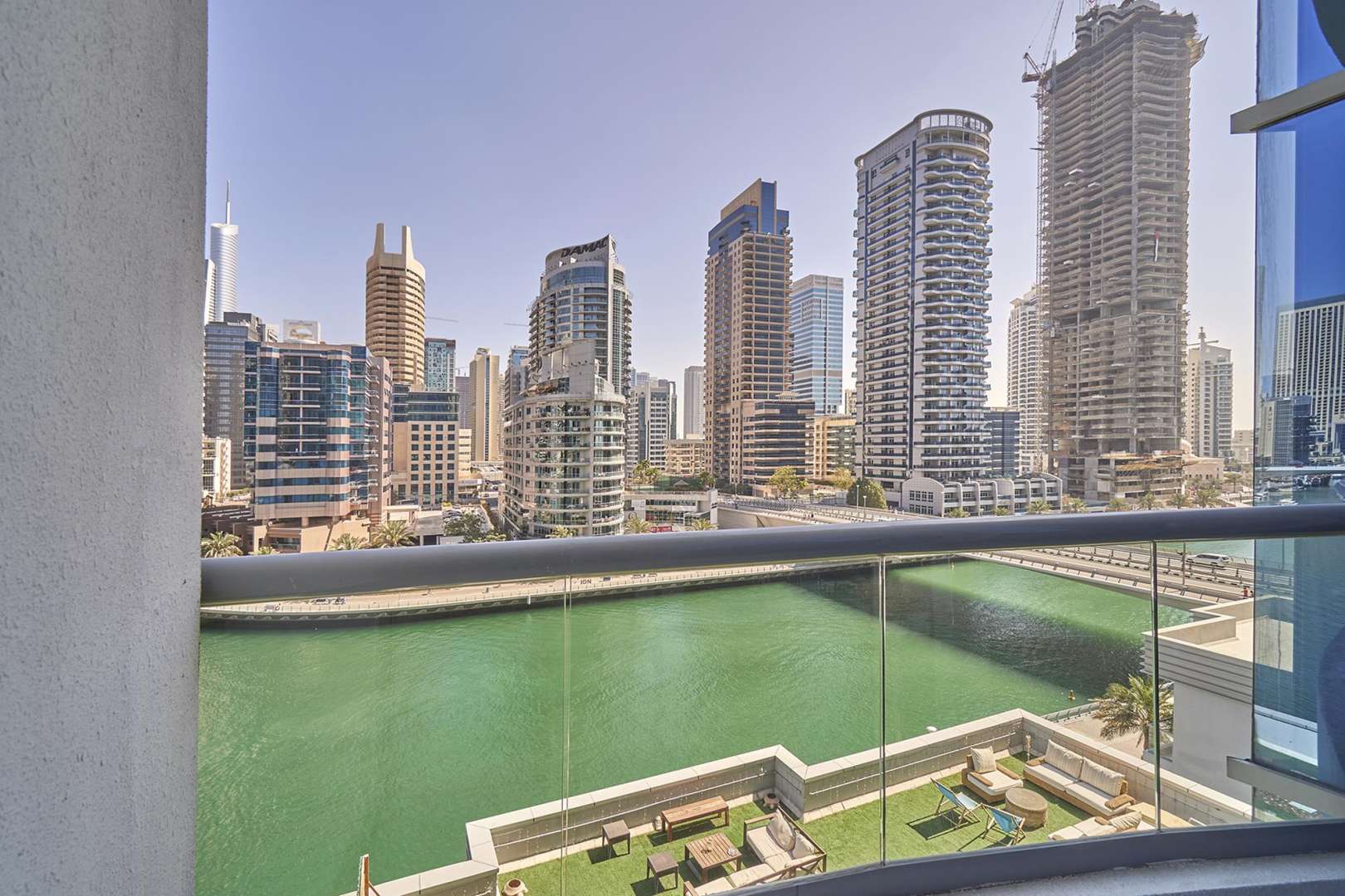 Spacious living area with large windows in Dubai Marina apartment for rent