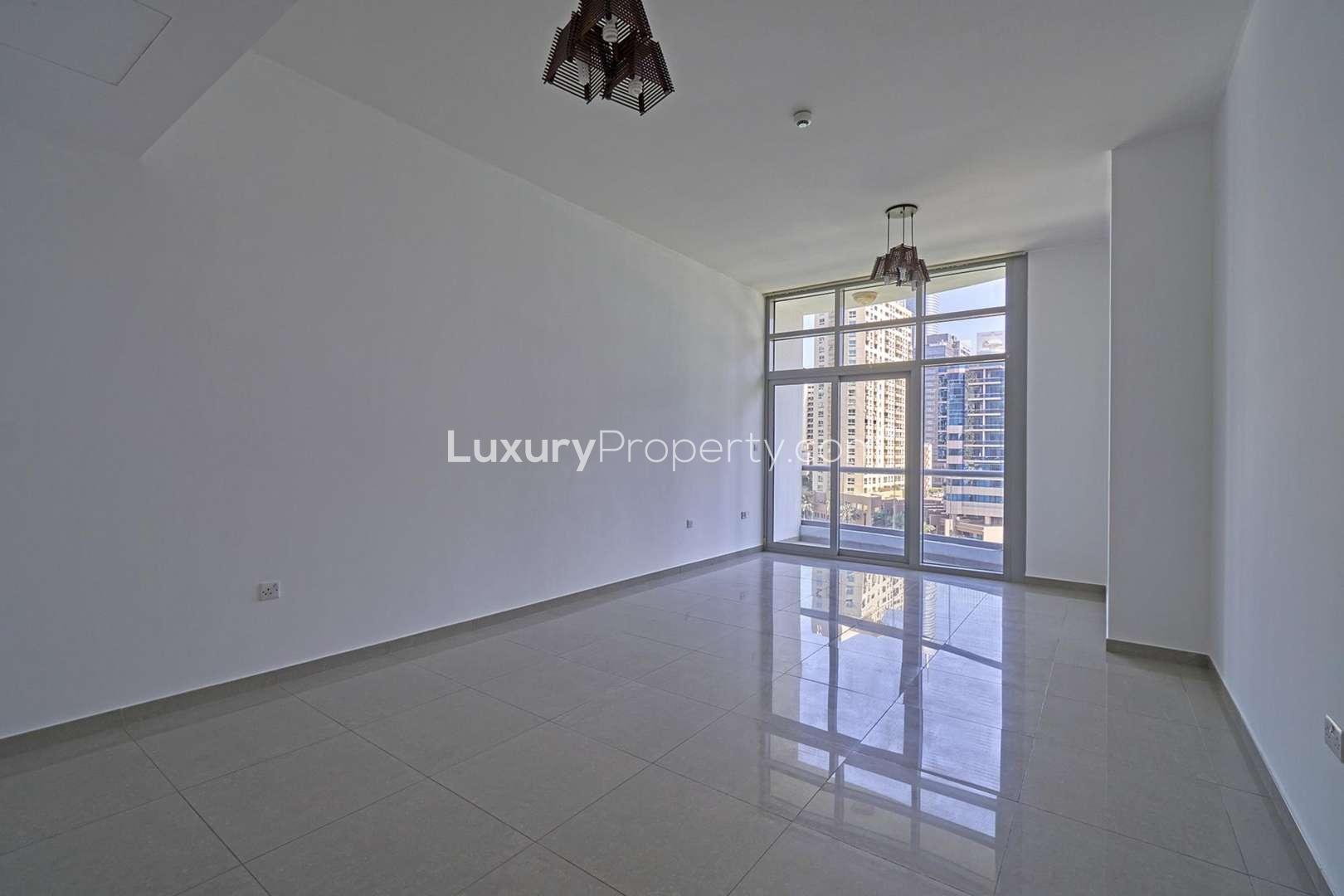Bright living room with large windows in Dubai Marina apartment for rent